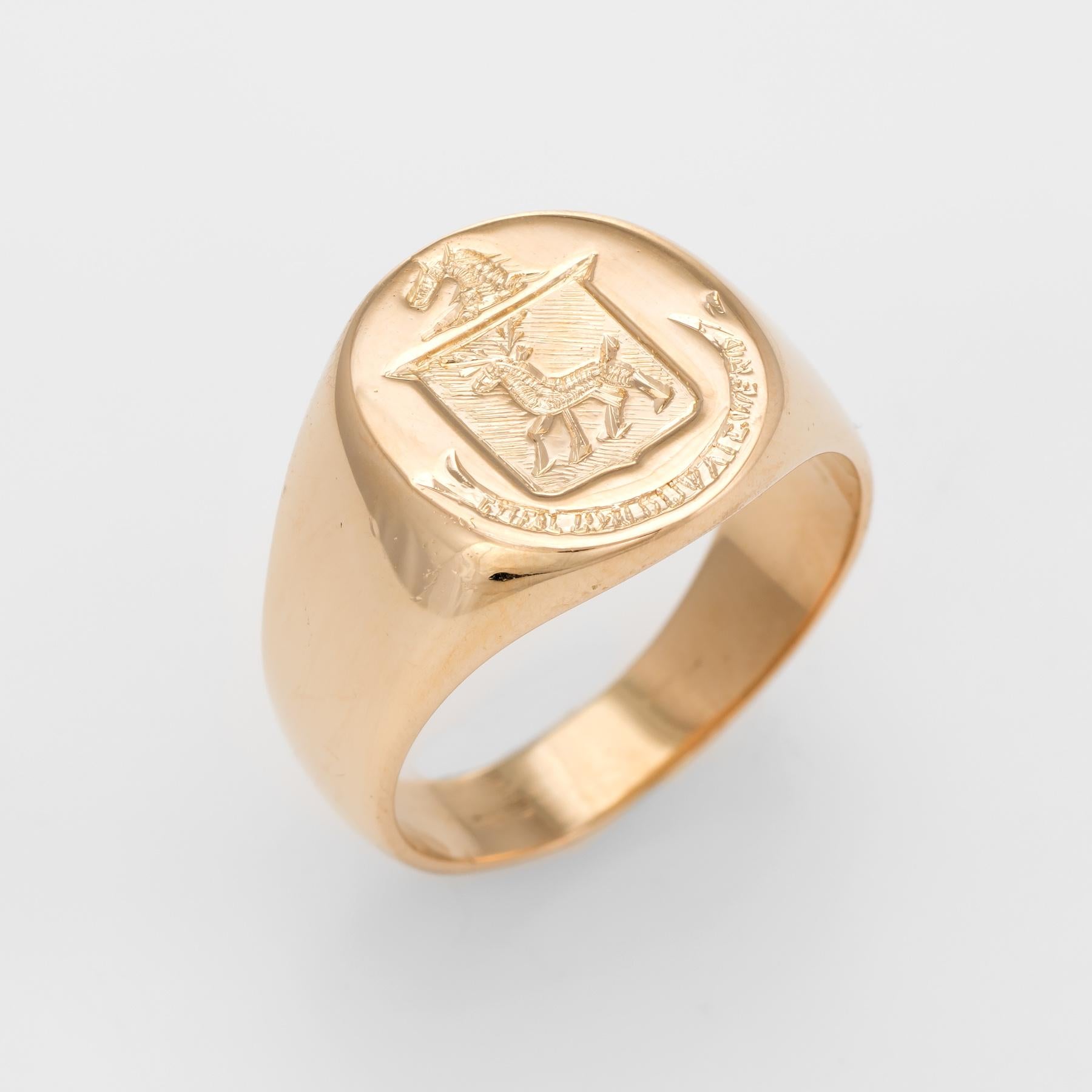 Finely detailed Men's signet ring (circa 1960s to 1970s), crafted in 18 karat yellow gold. 
Estate Jewelry Heirloom 8

The mount features a family crest with a deer in the center. The surrounding script is very hard to read (we believe it is Latin)