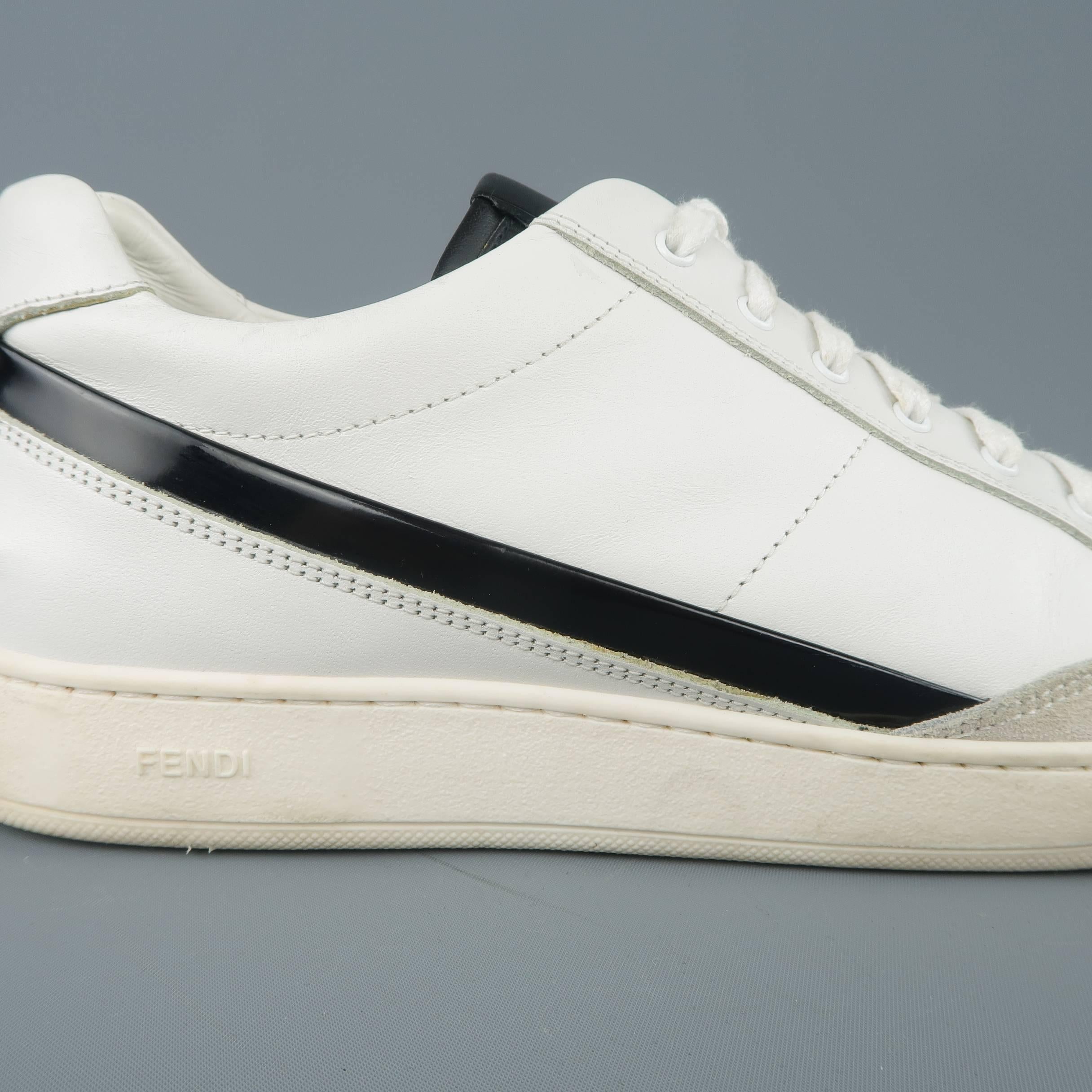 FENDI sneakers in white smooth leather with a lace up front, black tongue, grey suede detail, and black patent leather stripe. Wear throughout. Made in Italy.
 
Fair Pre-Owned Condition.
Marked: UK 7
 
Outsole: 11.5 x 4 in.
