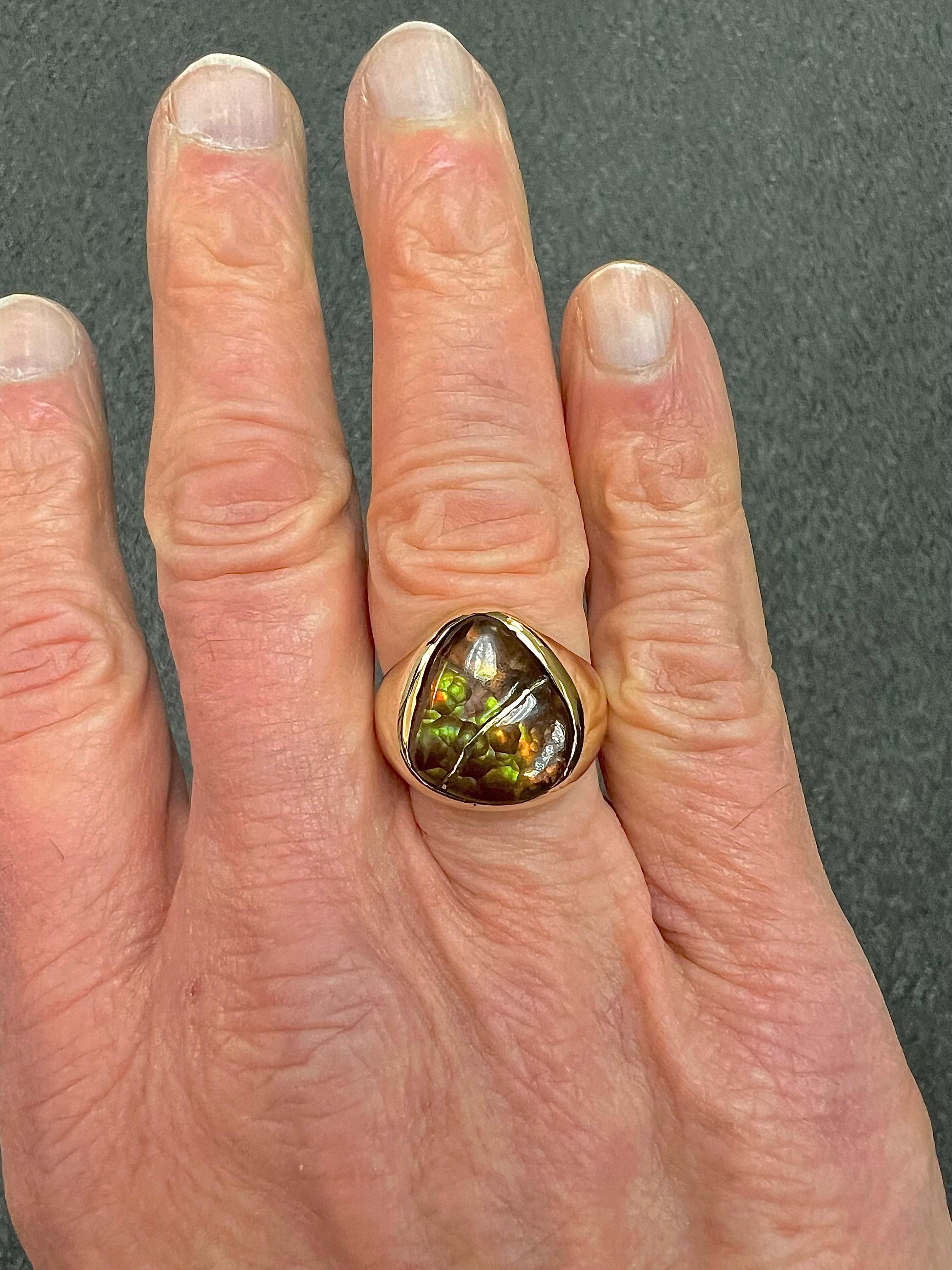 Men's Fire Agate 14k Yellow Gold Ring, Circa 1980.

The Men's Fire Agate 14k Yellow Gold Ring from the 1980s was custom made for this captivating fire agate stone.  The free form modified pear shape agate displays vibrant orange, green, and brown