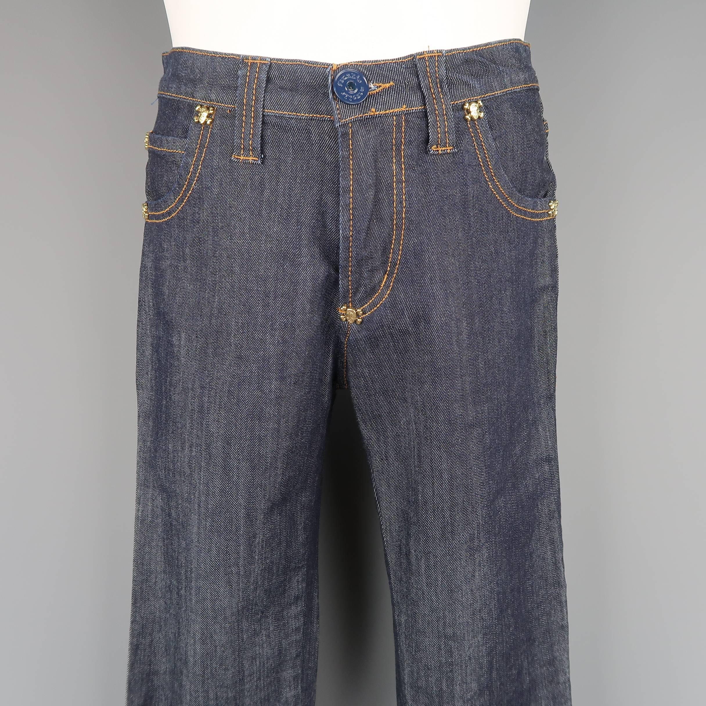 FRANKIE MORELLO jeans come in classic indigo raw denim with orange contrast stitching, a slim straight leg, and gold tone metal skull crossbones studs throughout.
 
New with Tags.
Marked: 30
 
Measurements:
 
Waist: 30 in.
Rise: 9.5 in.
Inseam: 31