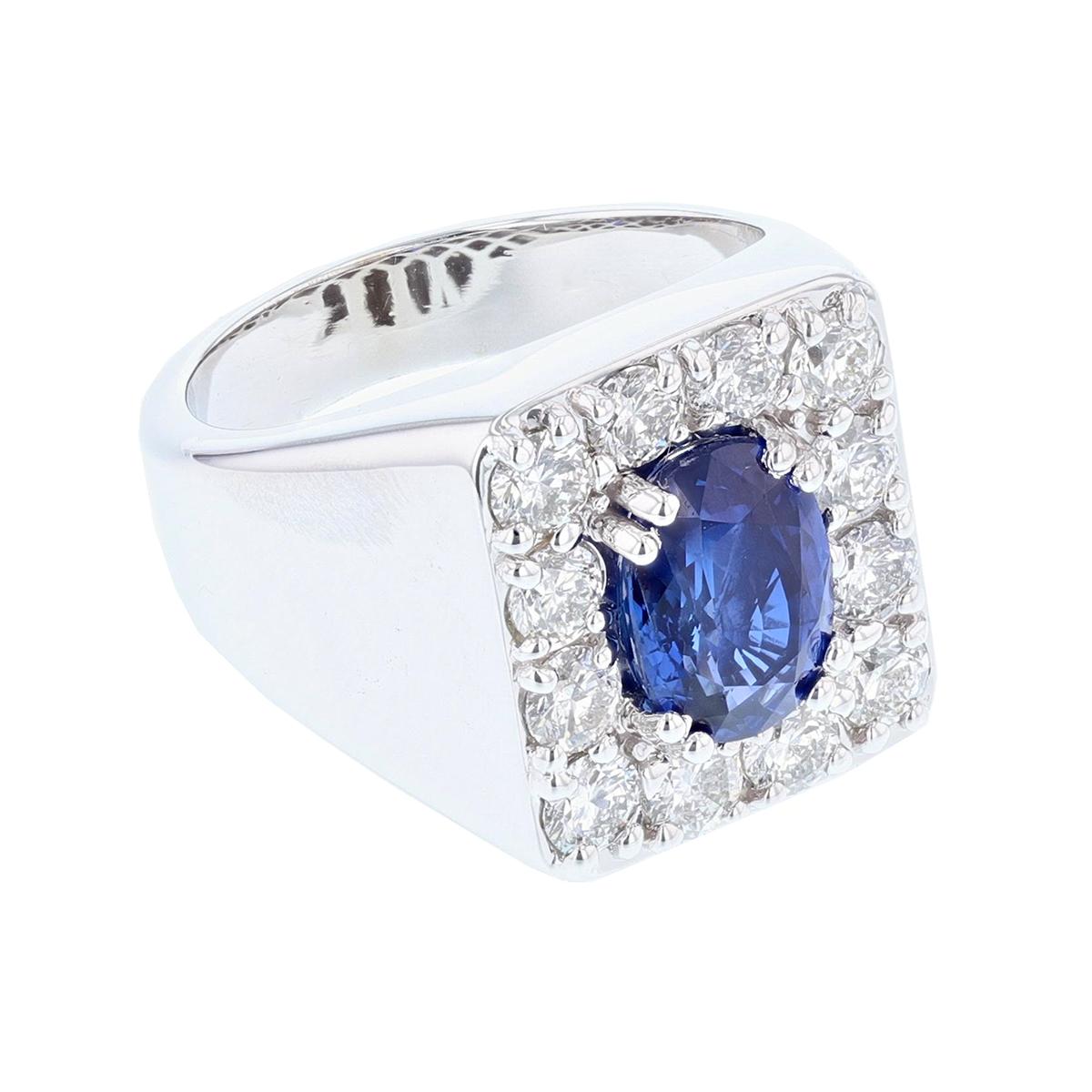 This gent's ring is made in 14 karat white gold featuring one oval cut, GIA certified, Natural Blue Madagascar Sapphire weighing 4.05 ct that is prong set. The certificate number is GIA 2205469285. The ring features 12 round cut diamonds, prong set