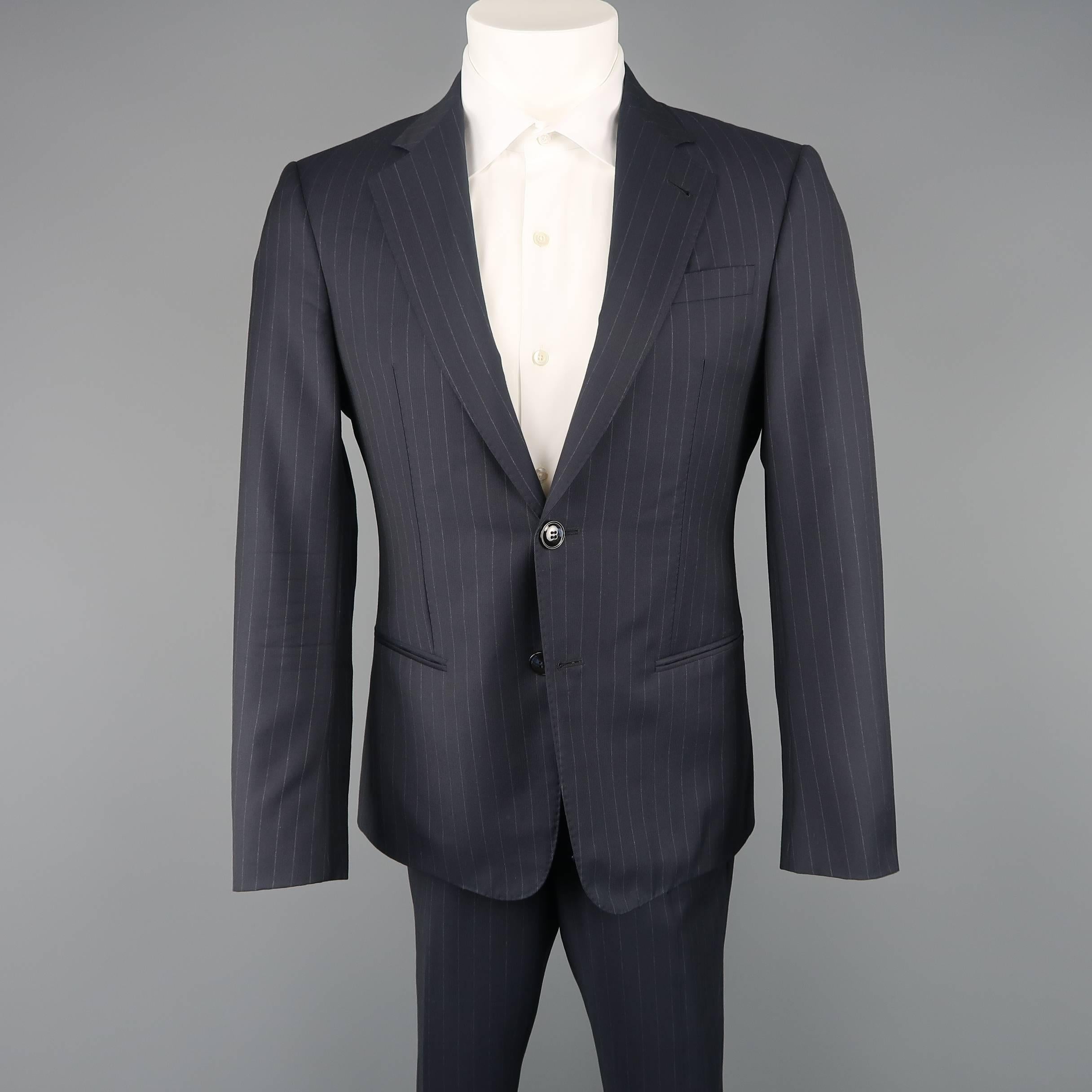 Classic GIORGIO ARMANI two piece suit comes in navy chalk stripe wool and includes a two button, single breasted sport coat with notch lapel and matching flat front trousers. Made in Italy.
 
Good Pre-Owned Condition.
Marked: IT 46
 
Measurements:
