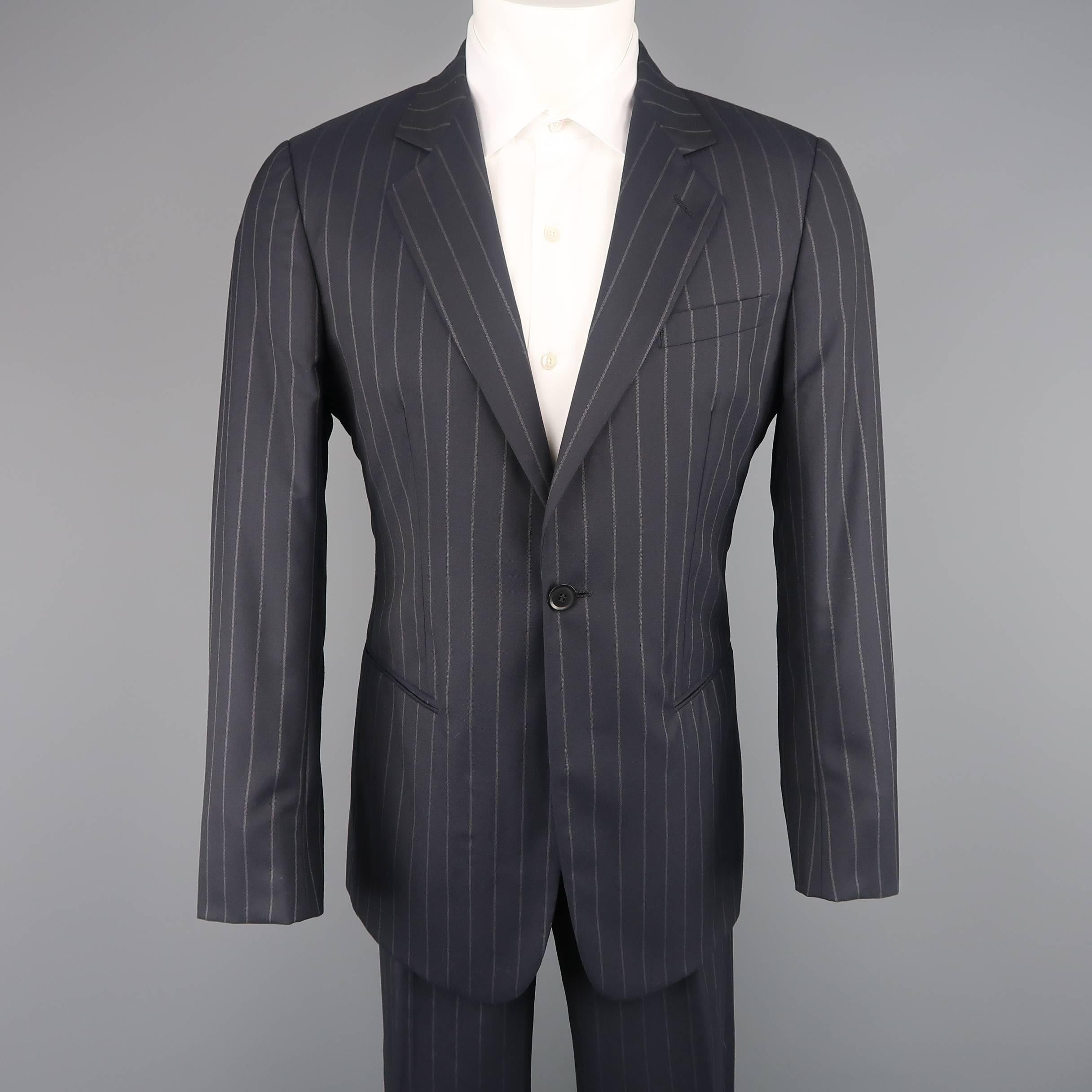 Two piece GIORGIO ARMANI suit comes in navy and grey chalk stripe wool and includes a single breasted, notch lapel sport coat with single button closure and matching straight leg dress pants. Made in Italy.
 
Good Pre-Owned Condition.
Marked: IT 50

