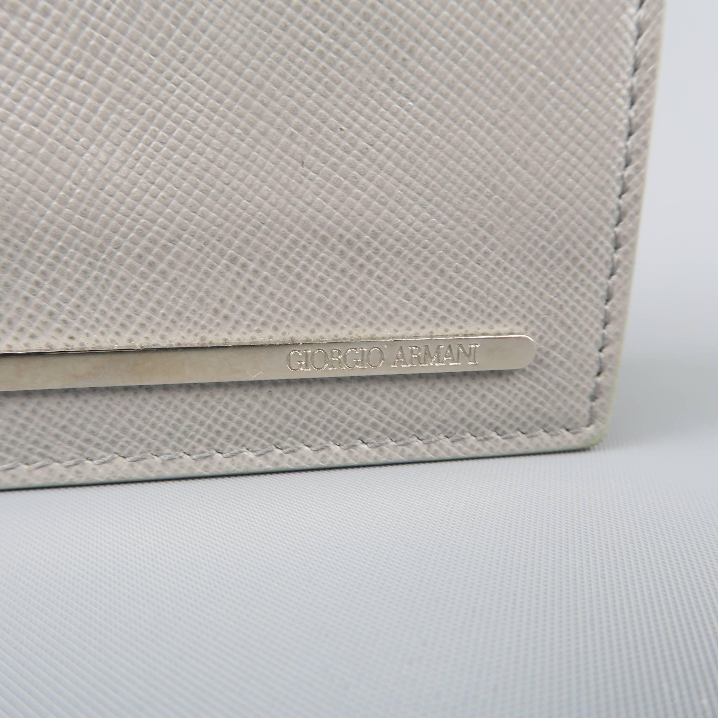 GIORGIO ARMANI bifold wallet comes in light gray textured leather with a silver tone embossed logo plaque, internal card slots and metal money clip. Made in Italy.
 
Fair Pre-Owned Condition.
 
4 x 3.25 in.
