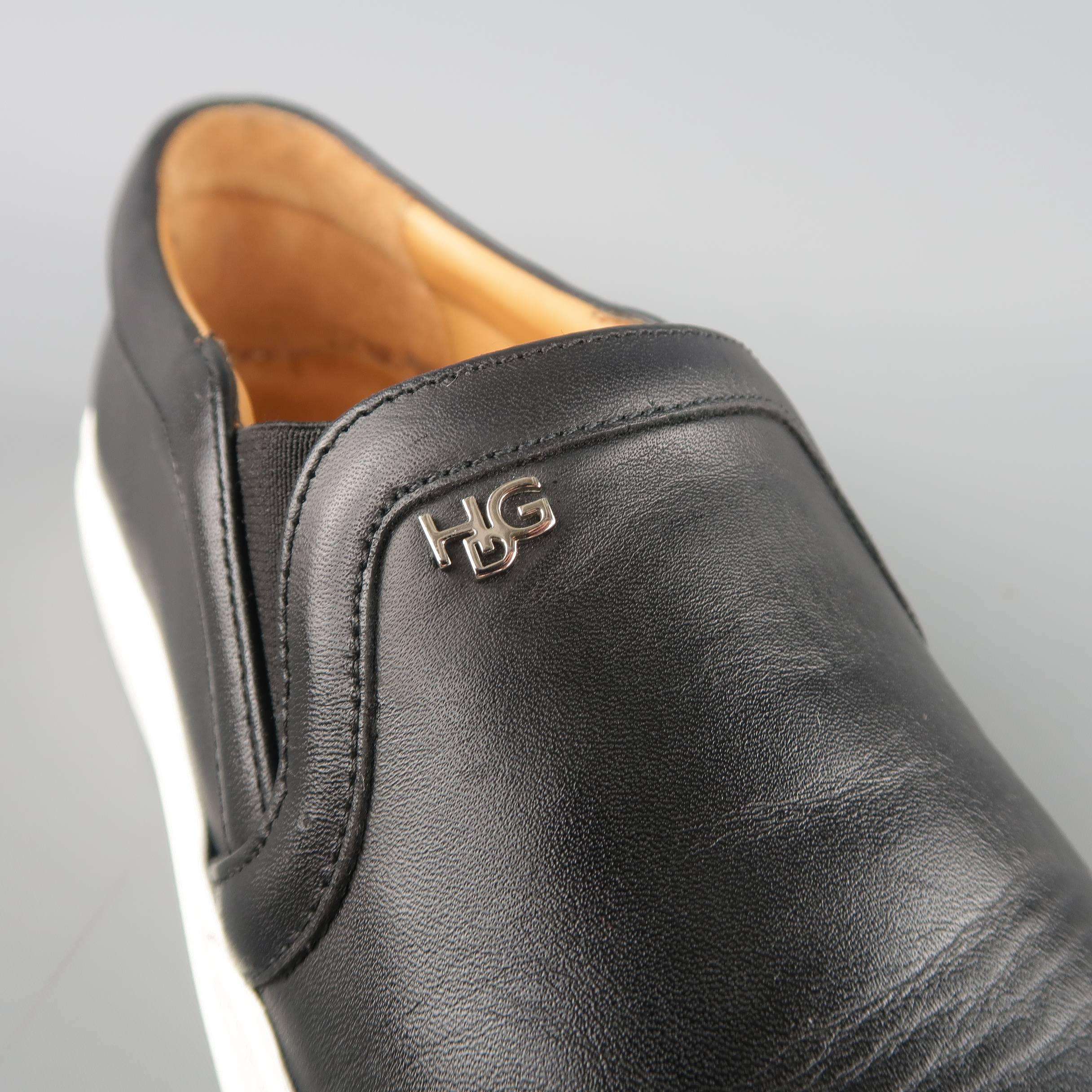 GIVENCHY slip on sneakers by Riccardo Tisci come in black smooth leather with a white rubber sole and silver tone 