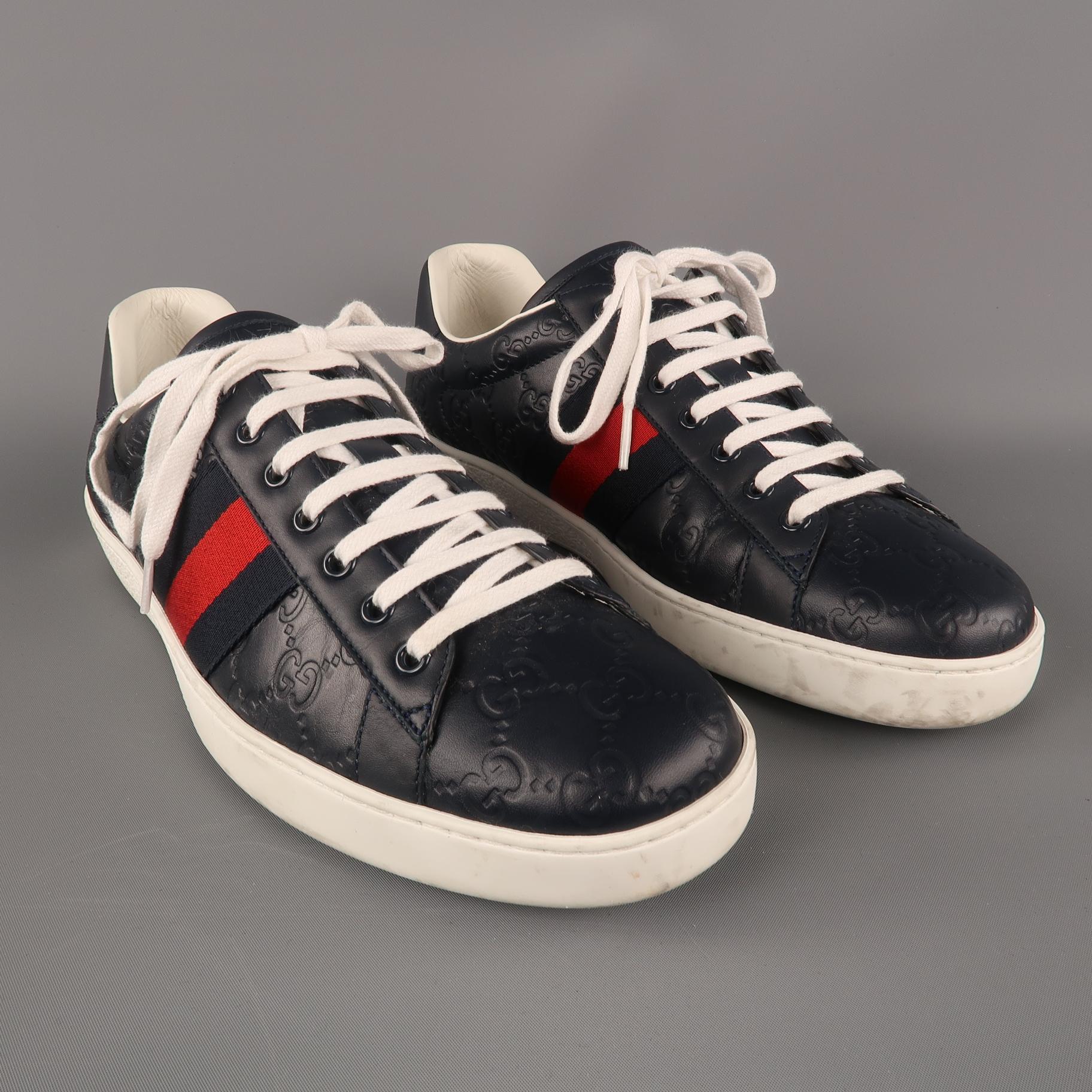 ACE GUCCI Signature Sneakers comes in a navy tone in a Guccissima embossed leather material, with a blue and red web, a white rubber sole, lace up. Made in Italy.
 
Excellent Pre-Owned Condition.
Marked: UK 10
 
Outsole: 12 x 4.5 in.