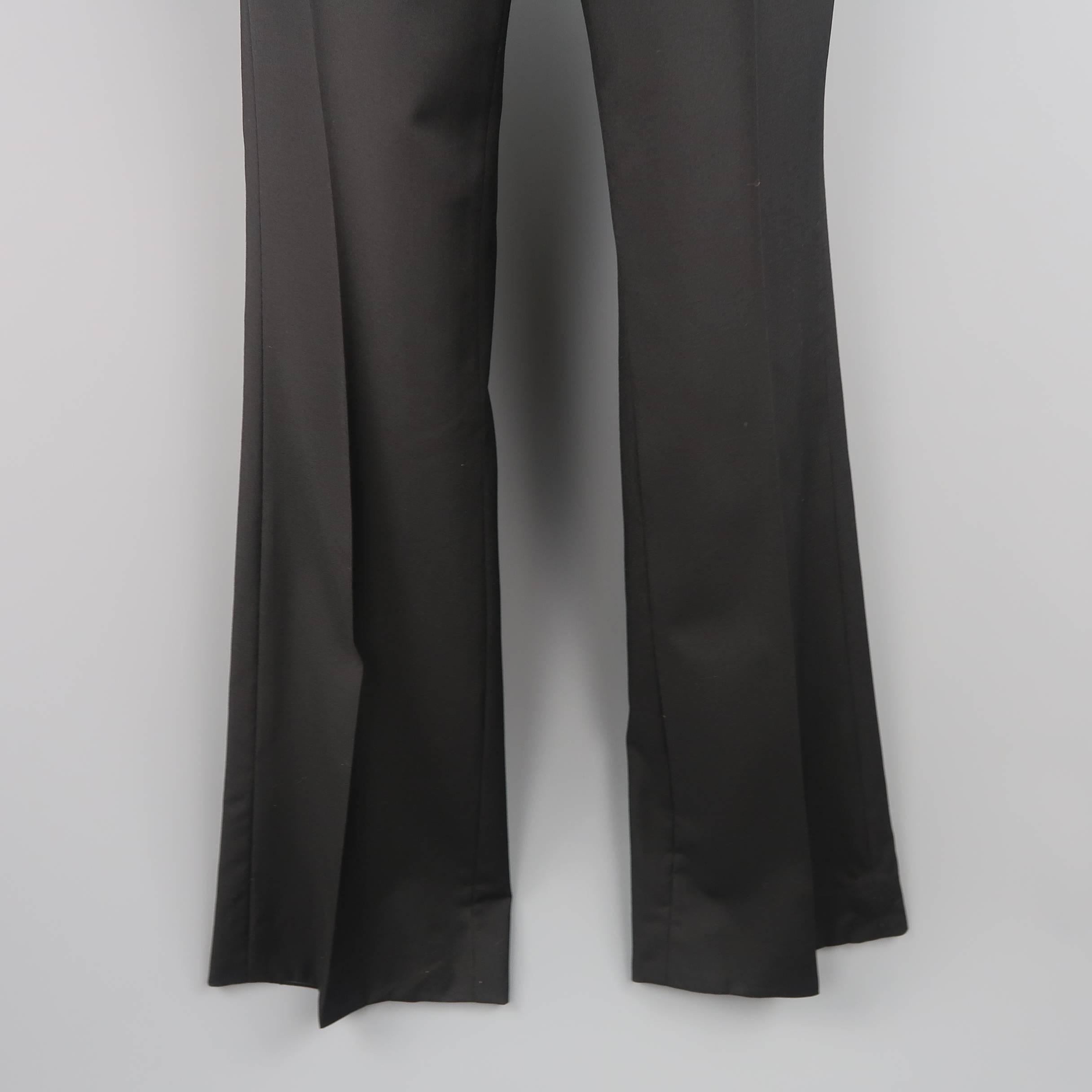 Rare GUCCI by TOM FORD Spring Summer 2000 dress pants come in black wool with a flat front and flaired bell bottom leg. Made in Italy.
 
Good Pre-Owned Condition.
Marked: IT 46 R
 
Measurements:
 
Waist: 31 in. (+1 in. )
Rise: 10.5 in.
Inseam: 35
