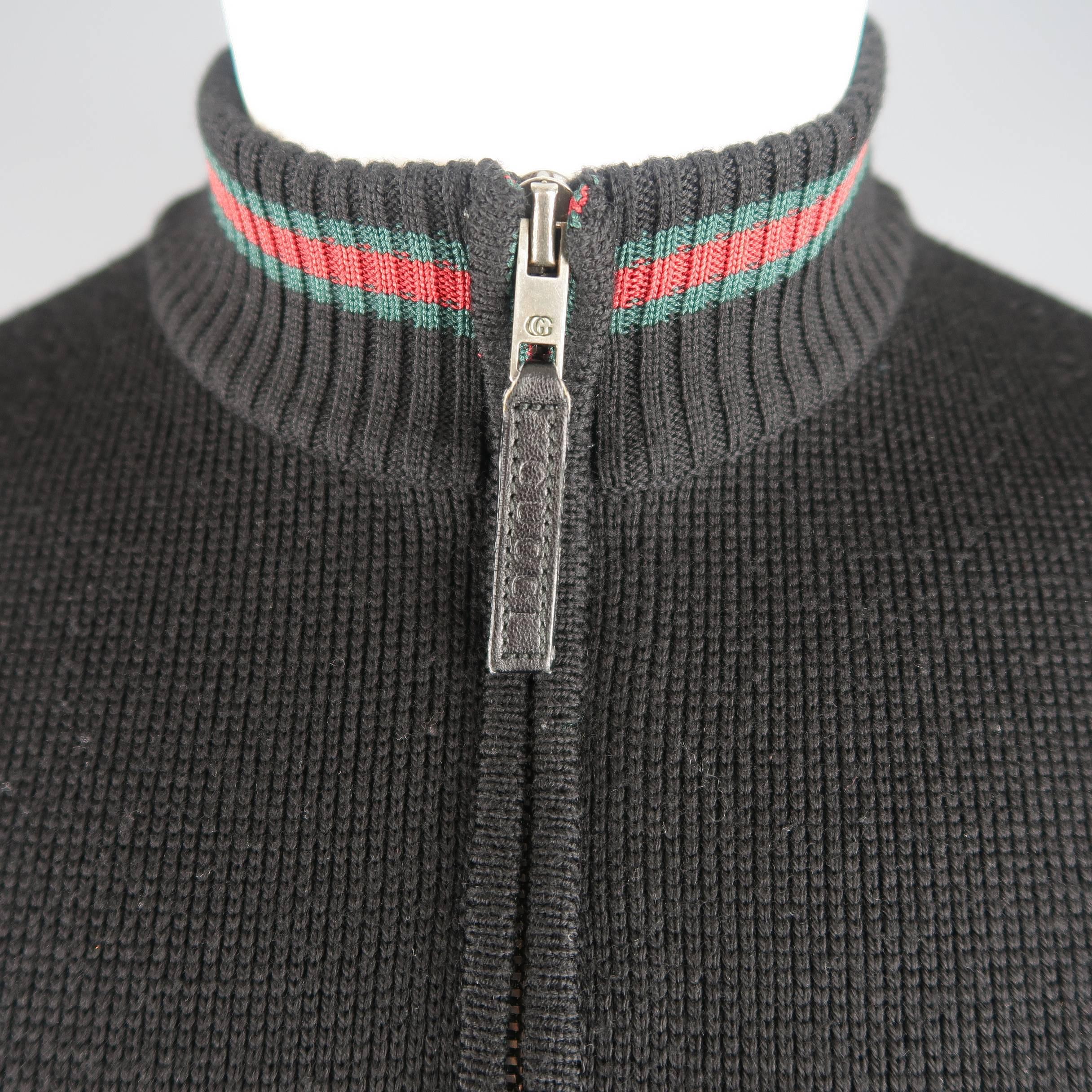 GUCCI cardigan sweater comes in black wool knit with a double zip front, mock neck  collar, slanted pockets, and signature red and green stripe accents. Made in Italy.
 
Good Pre-Owned Condition.
Marked: S
 
Measurements:
 
Shoulder: 17 in.
Chest: