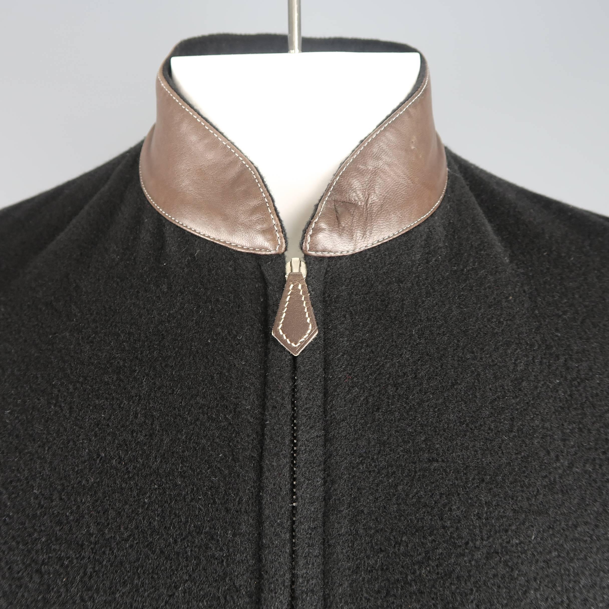 HERMES jacket comes in black cashmere knit with a zip up front, slanted zip pockets, snap tab cuff sleeves, and brown leather stand up baseball collar. Small hole on collar. Made in France.
 
Good Pre-Owned Condition.
Marked: IT 46
 
Measurements:
