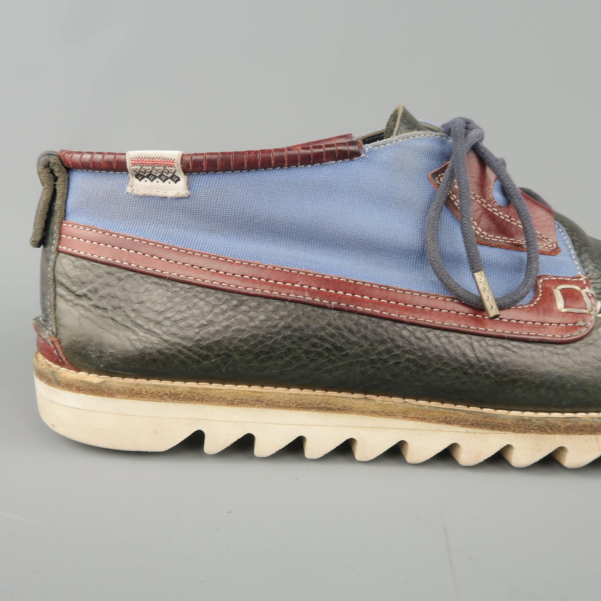 HESCHUNG boat shoe comes in a deep olive tone navy leather with light blue canvas panel, apron toe, tan leather details, and white shark sole. Wear throughout. Made in France.
 
Fair Pre-Owned Condition.
Marked:UK 8.5
 
Outsole: 12 x 4 in.
