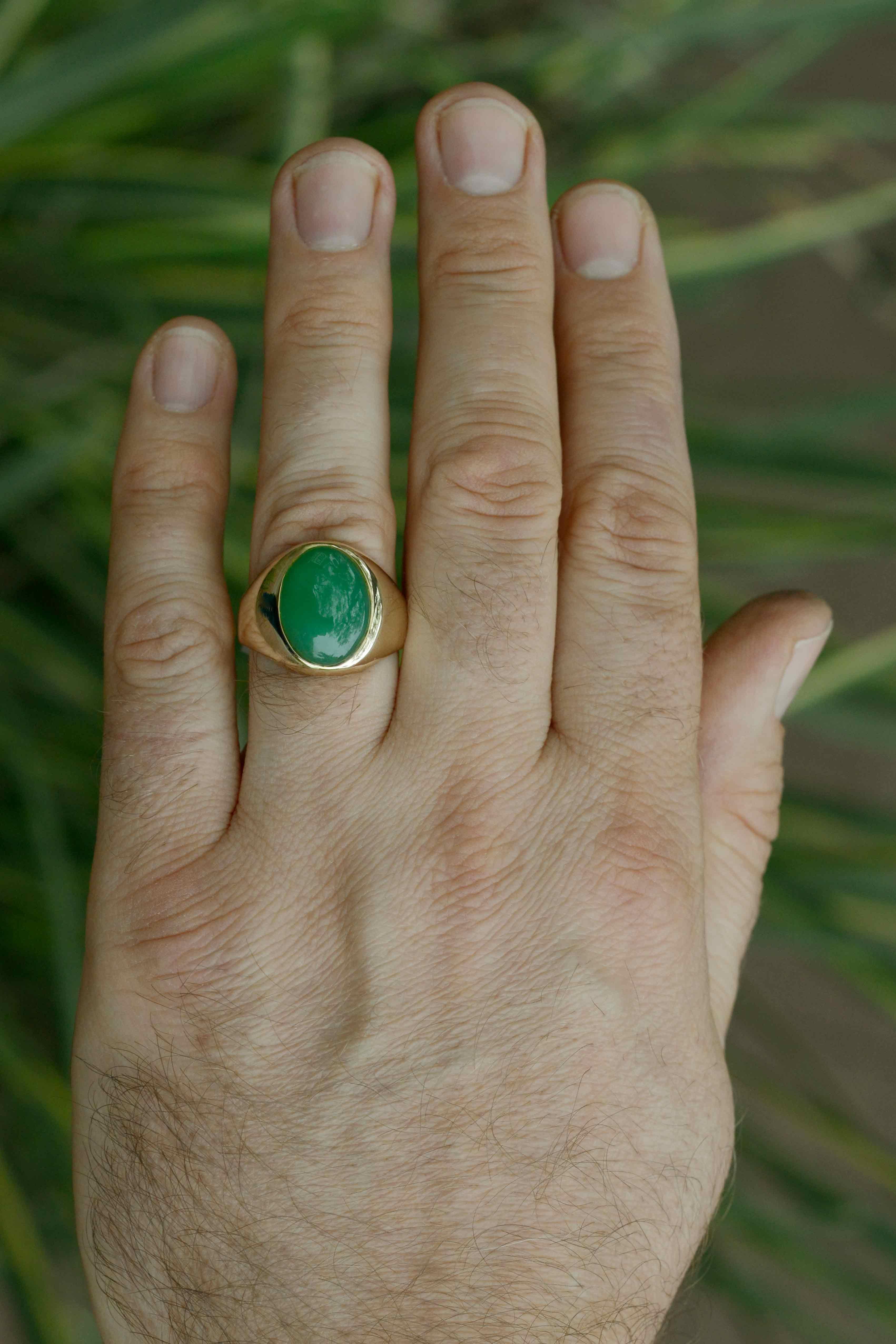 An imperial Burmese jade men's dress ring. Artfully placed in rich 14K yellow gold, the crisp, apple green Burma gemstone supreme is cabochon cut with a subtle yet proud look, possessing even tone with deep saturation of color. Type A Jadeite