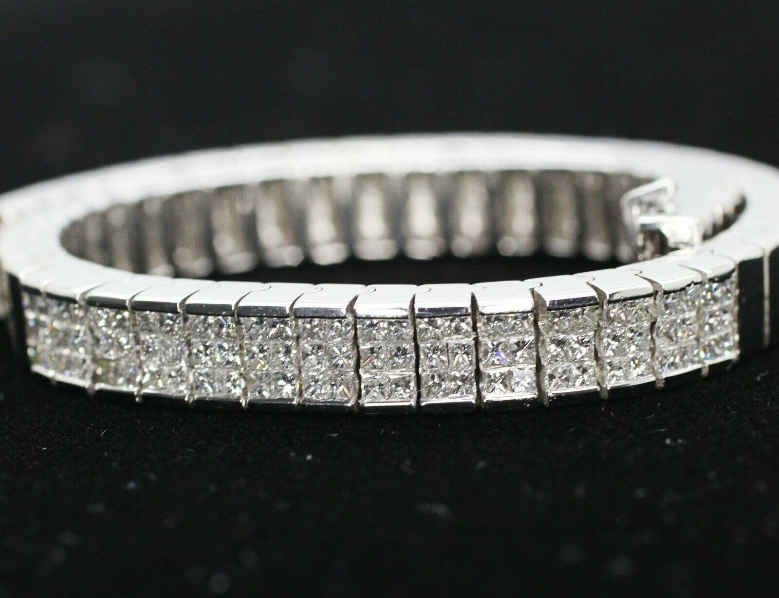  Invisible set diamond bracelet set in 14k white gold. There are 82 pieces of princess cut diamonds, with a clarity of VS and color of G/H in 1.50 carat total weight..The diamonds are invisible set in the high polish bracelet which has a width of