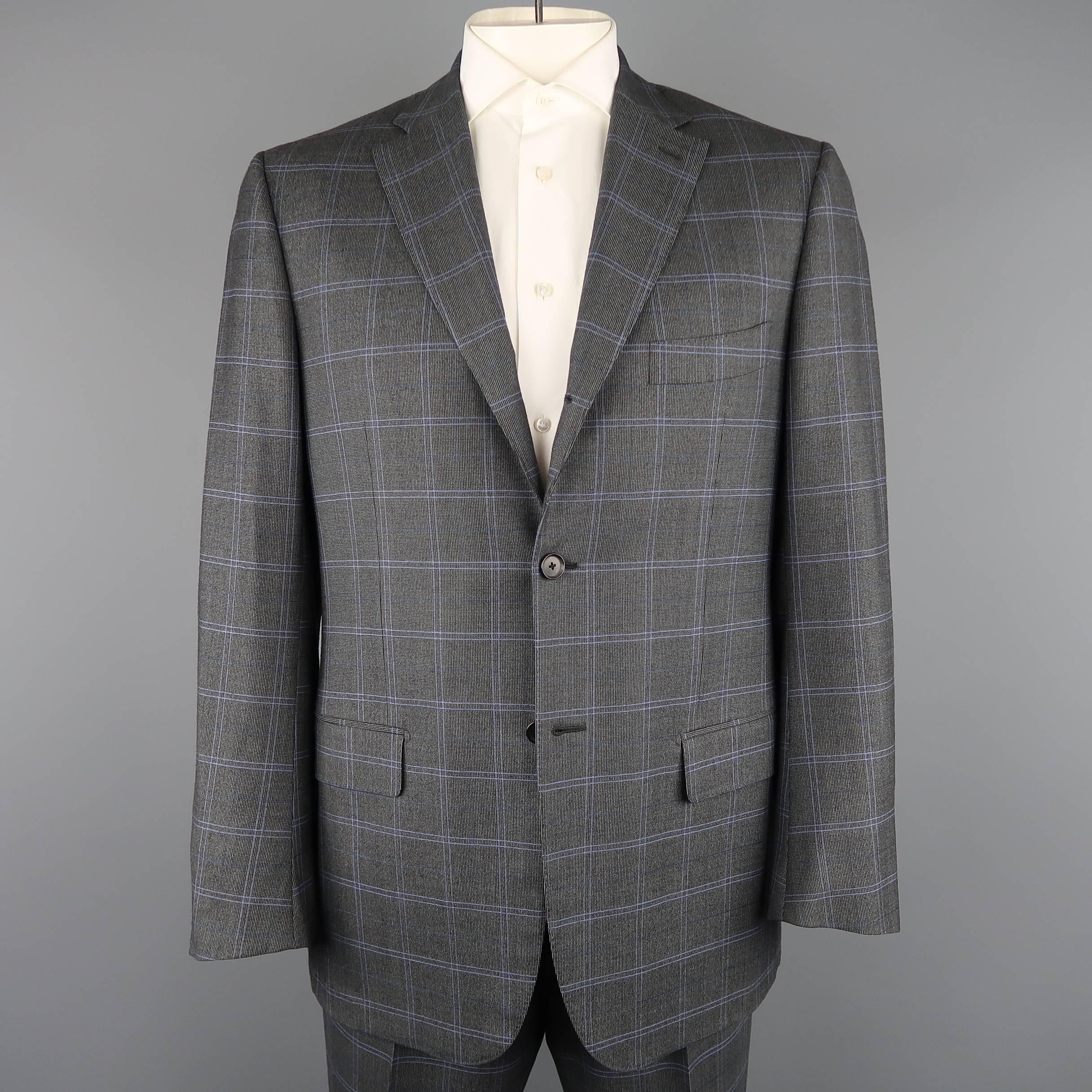 ISAIA two piece suit comes in dark gray wool with blue windowpane print throughout and includes a single breasted, three button, notch lapel sport coat with functional button cuffs and matching flat front, cuffed hem trousers. Made in Italy.
 
Good