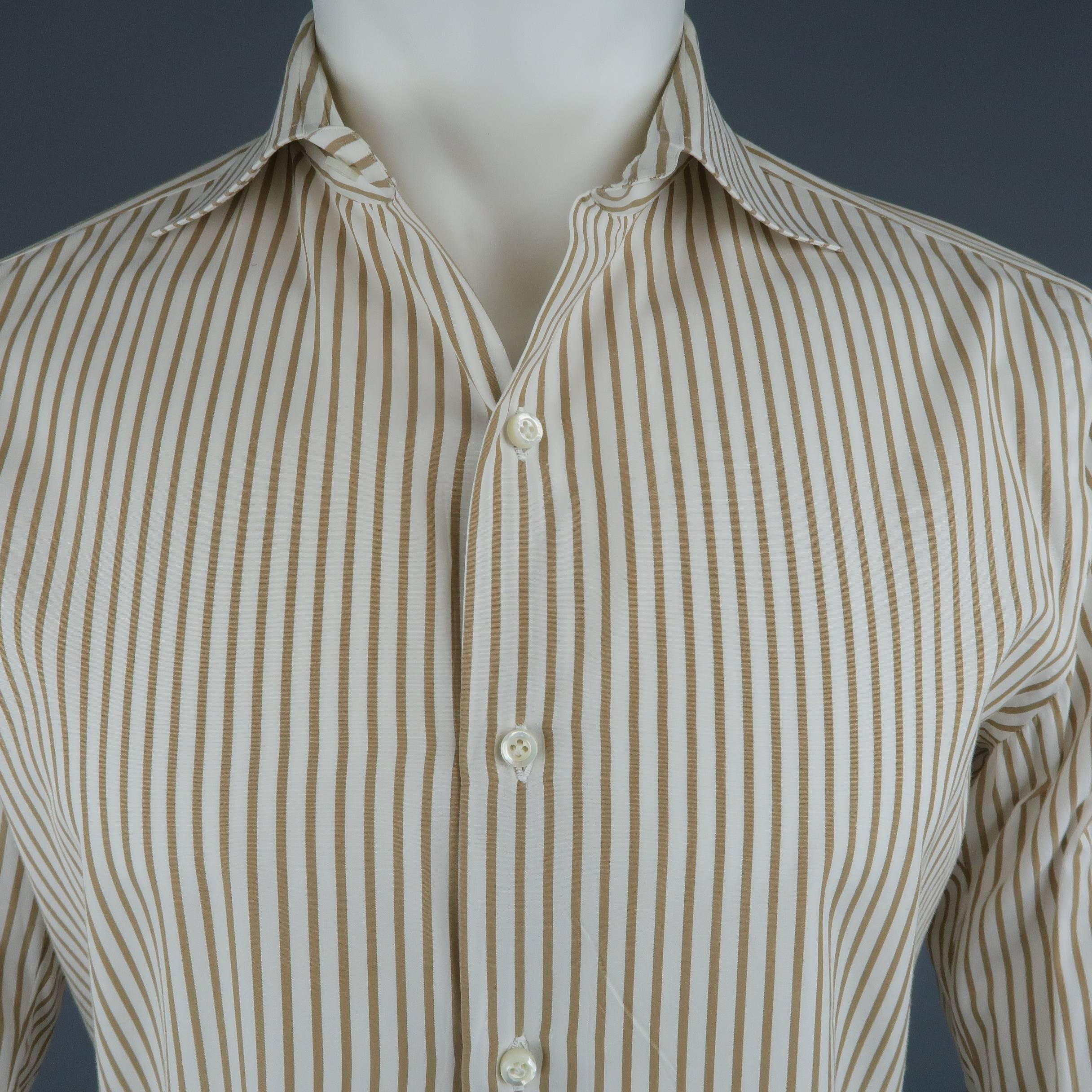 Classic dress shirt comes in khaki and white striped cotton with a spread collar. Made in Italy.
 
Good Pre-Owned Condition.
Marked: 15.5/39
 
Measurements:
 
Shoulder: 16.5 in.
Chest: 43 in.
Sleeve: 24 in.
Length: 30 in.
