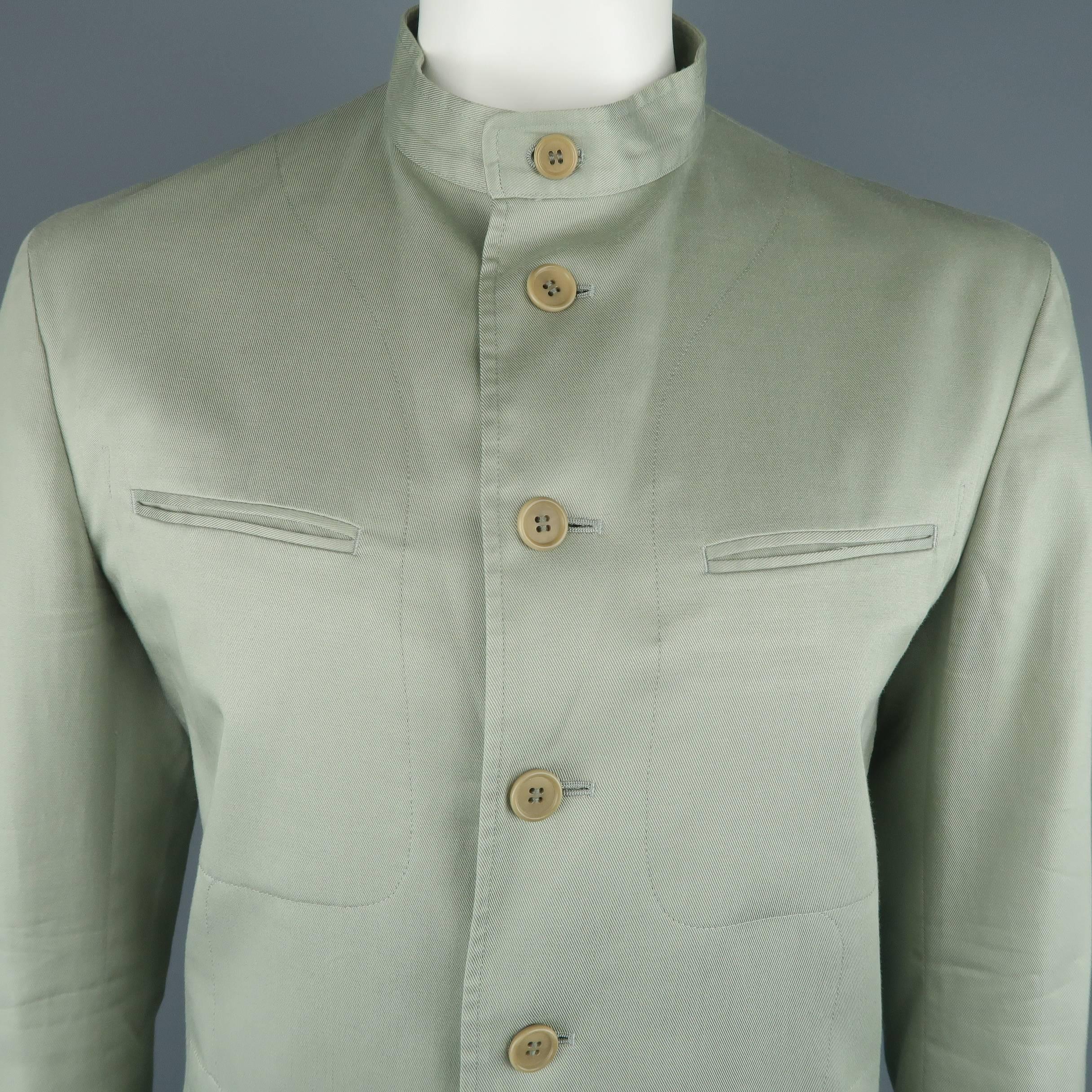Archive ISSEY MIYAKE jacket comes in muted sage green cotton twill with a Nehru band collar, six button front, and patch and flap pockets with seam details throughout. Made in Japan.
 
Excellent Pre-Owned Condition.
Marked: JP 3
 
Measurements:
