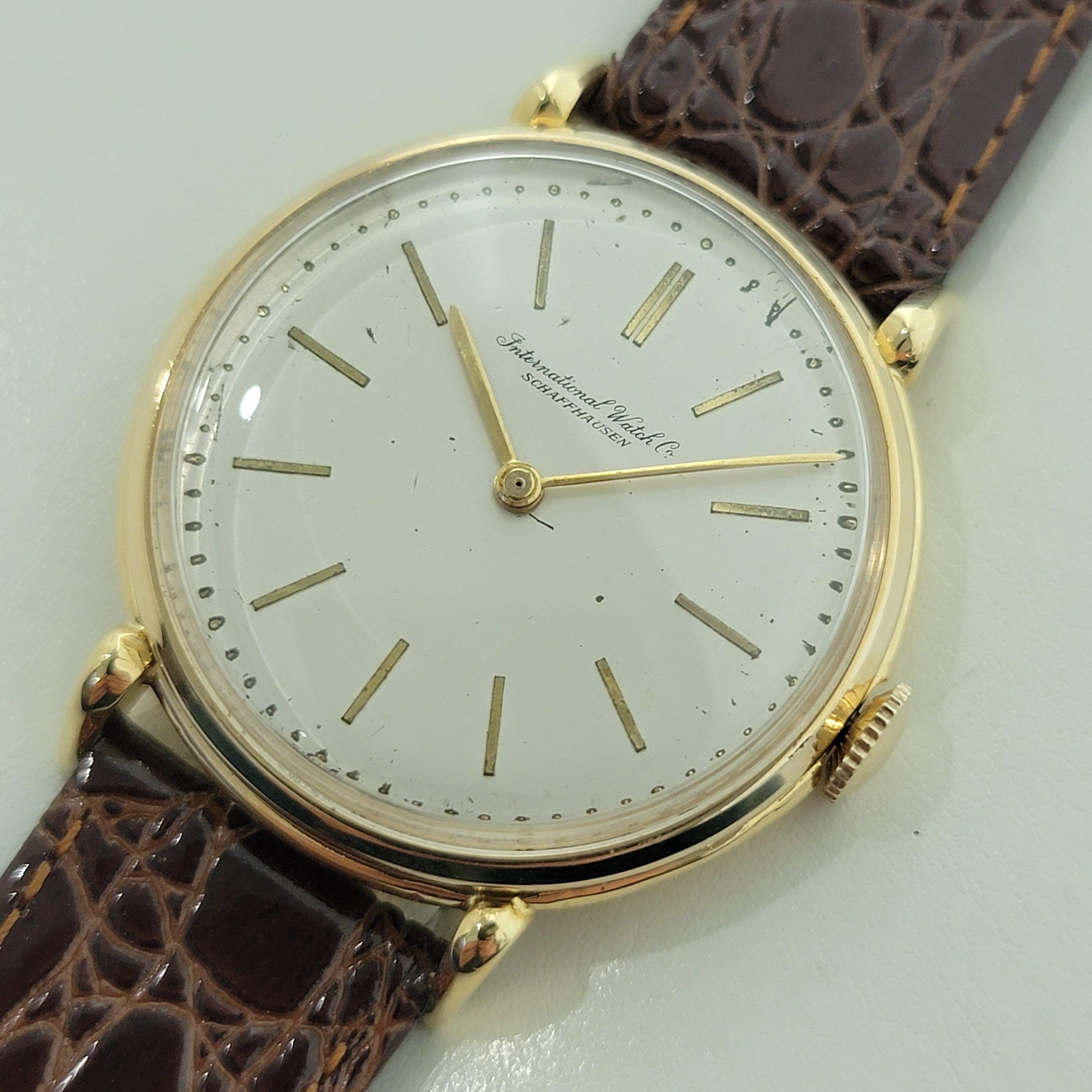 Timeless luxury, 18k solid gold Men's IWC Schaffhausen manual wind jumbo dress watch, c.1950s, in excellent working condition. Verified authentic by a master watchmaker. Gorgeous, IWC signed vintage dial, baton index hour markers, gilt minute and