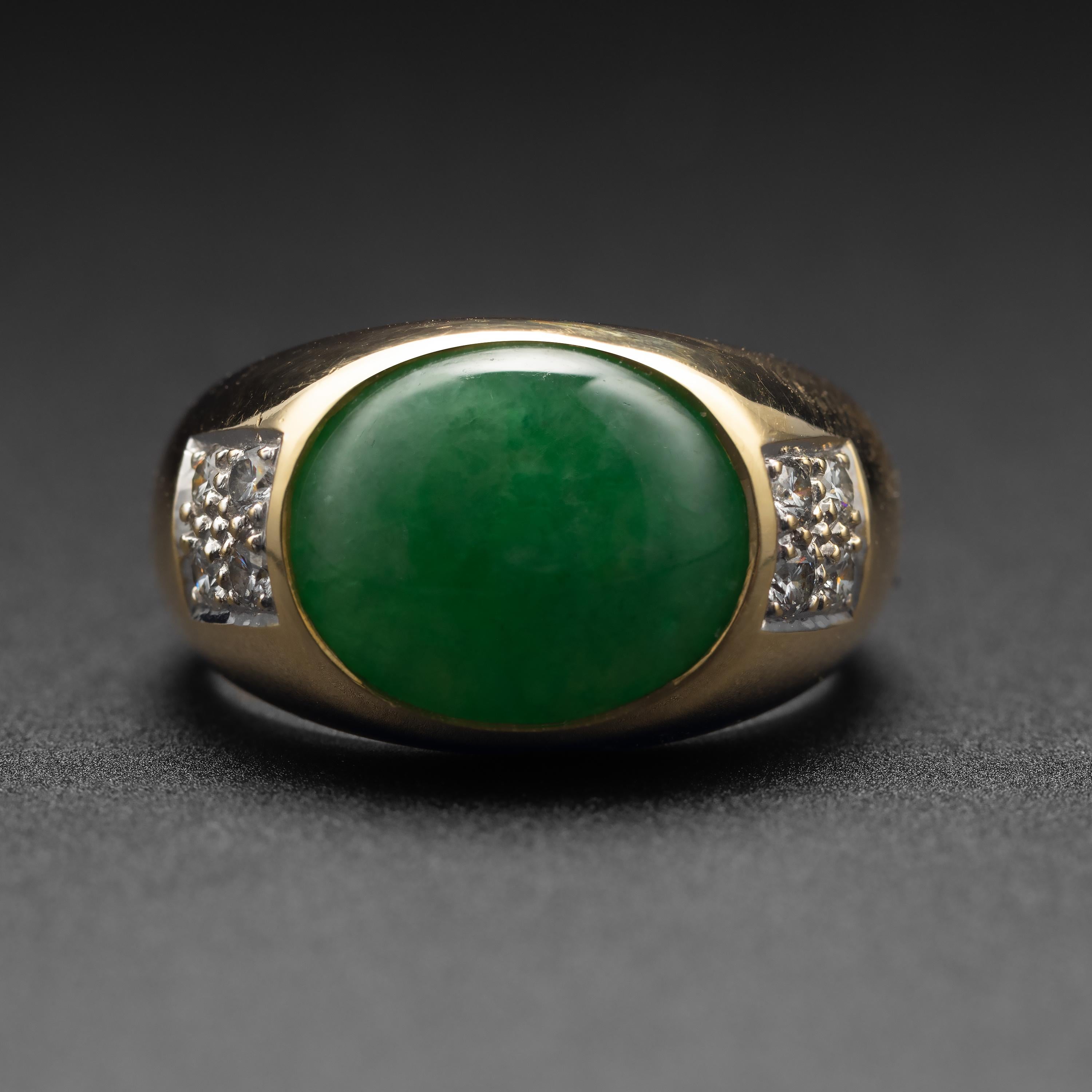 This vintage (circa 1980s) 18K yellow gold ring is sleek and timelessly classic. The focal point of, of course, is the vivid apple-green double cabochon of natural and untreated jadeite jade from Burma. The stone measures 13.25mm x 10.85mm and is