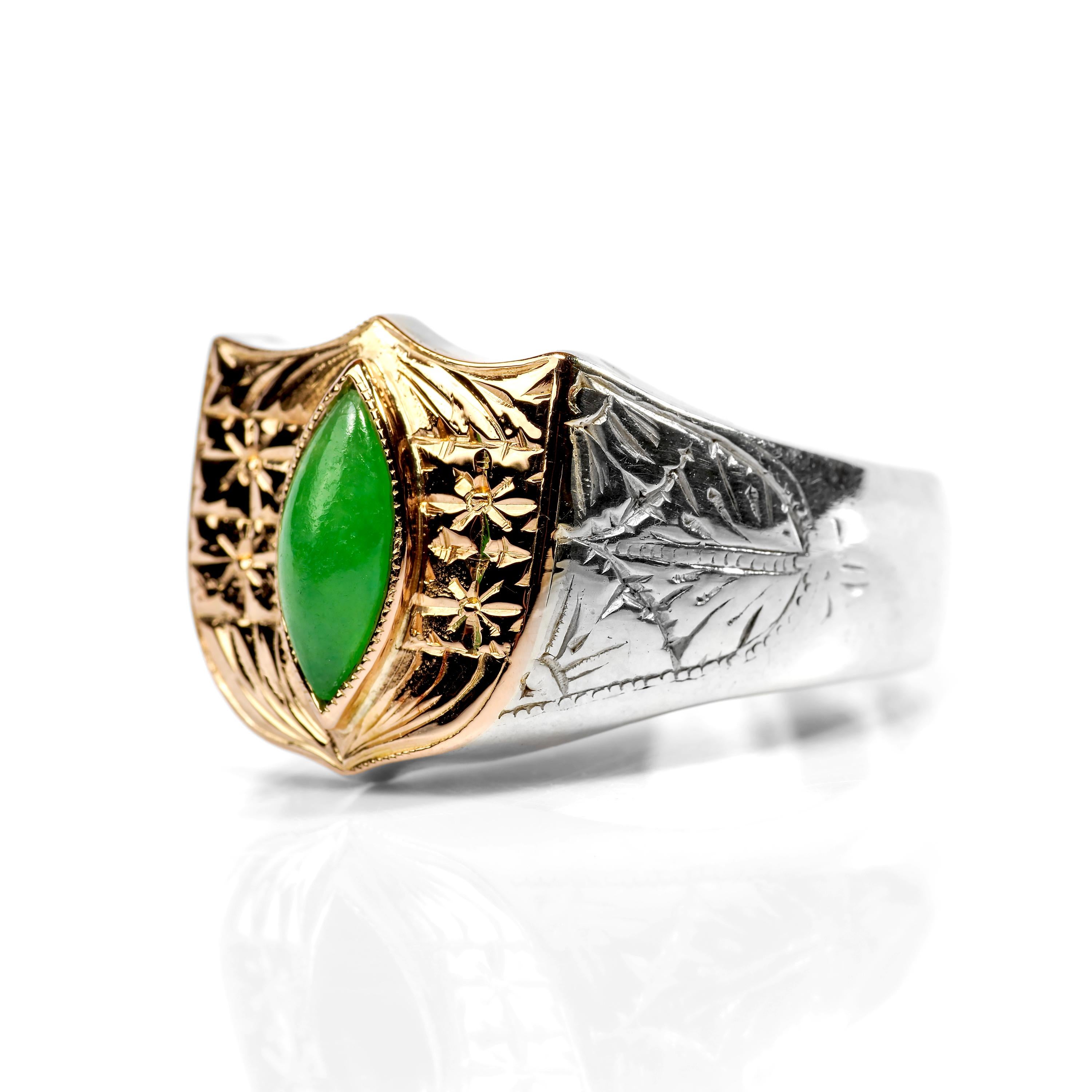 A shield of hand-engraved 18 rose gold holds a marquise cabochon of vivid apple green jadeite in this 18K white gold ring from Japan. Hand-crafted in the Art Deco era, this substantial ring is as beautiful as it is unique. The apple green jade is