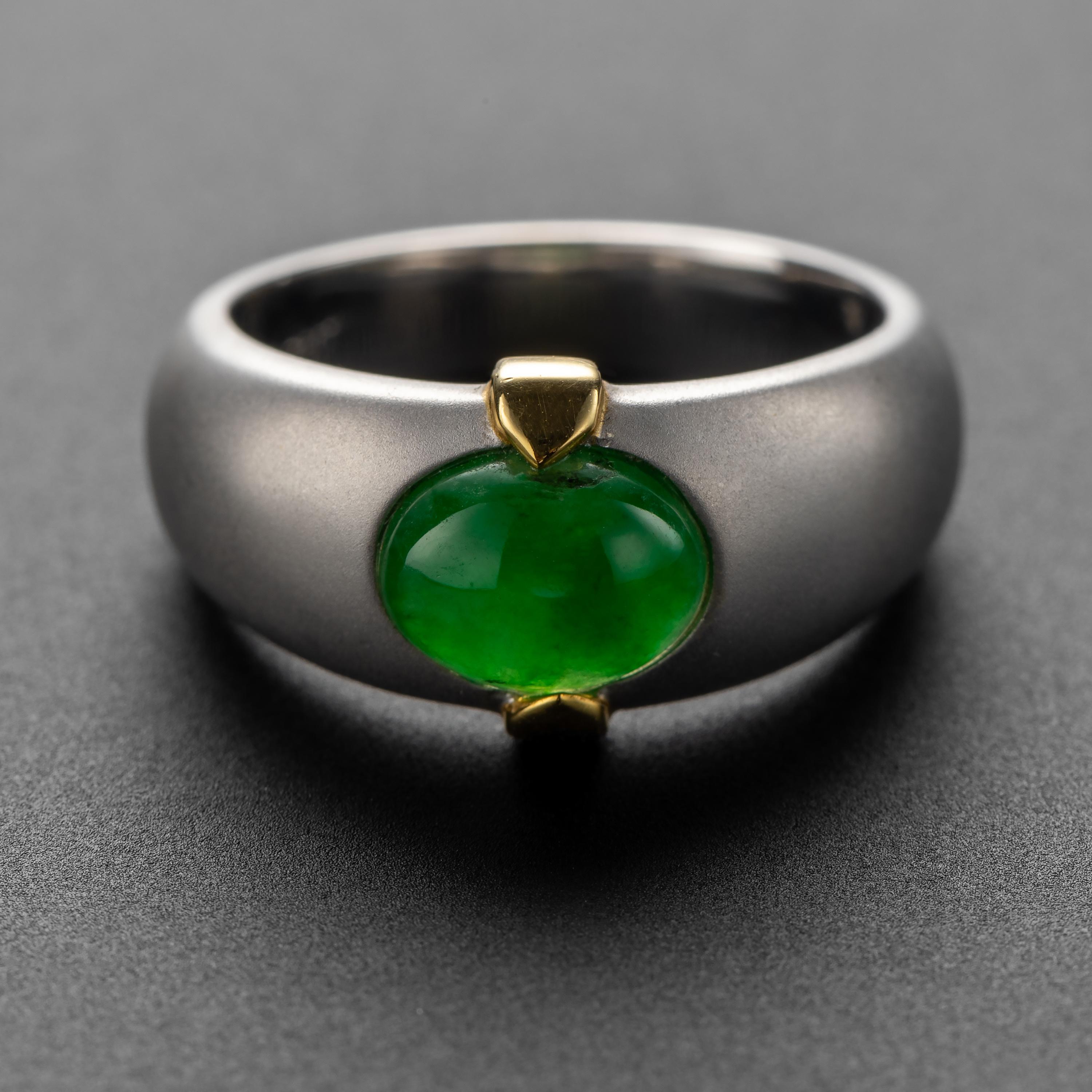 A spectacular and one-of-a-kind men's ring crafted in matt-finish 18K white and yellow gold and set with a rich emerald-green cabochon of translucent Burmese jadeite jade.  The ring has never been worn.

The highly saturated and translucent jade