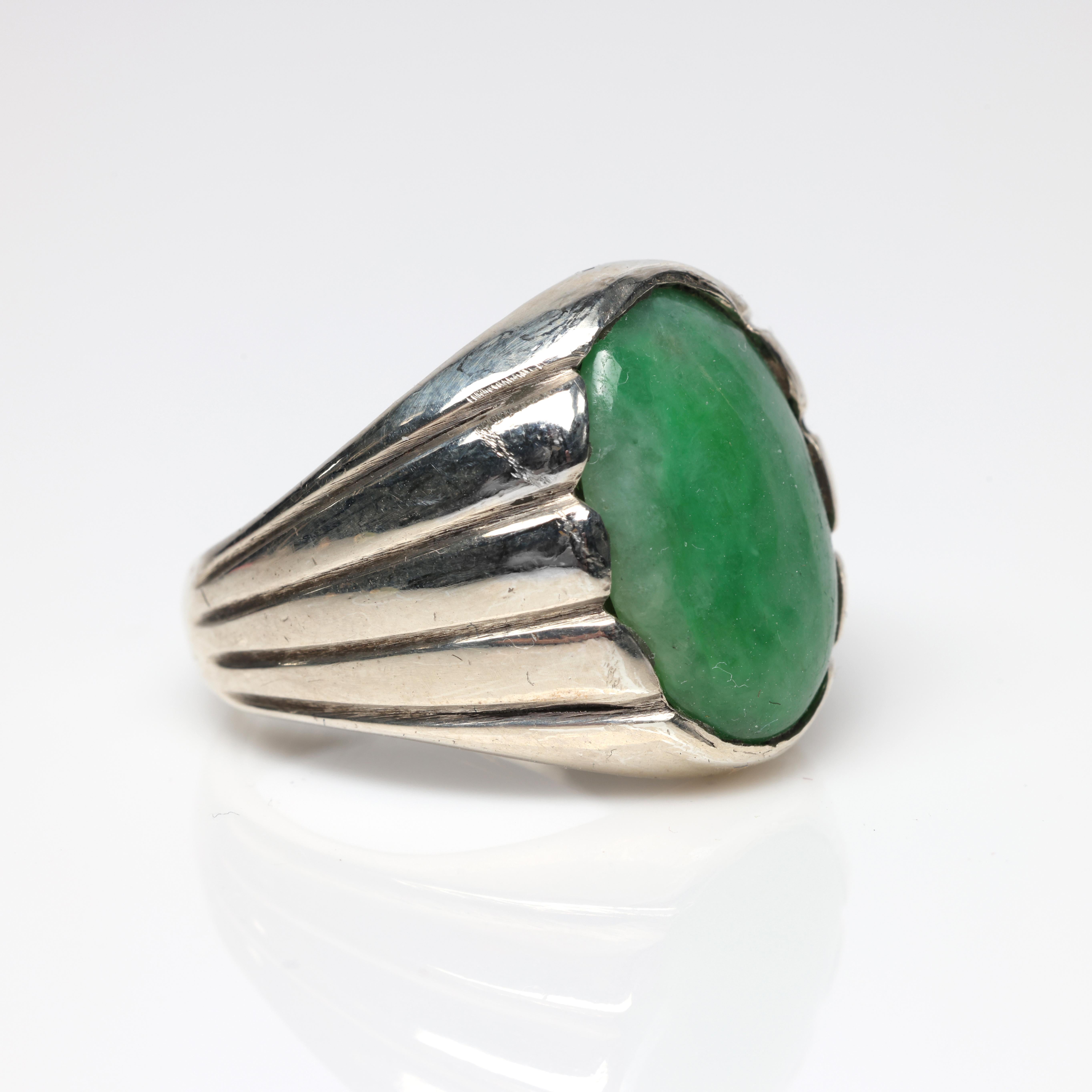 This men's jadeite jade ring features a sizeable (18.5mm x 12.25mm x 4.50mm) double cabochon of mottled Apple green jade. The stone is certified by Stone Group Labs to be natural and untreated jadeite from Burma and ships with the certificate you