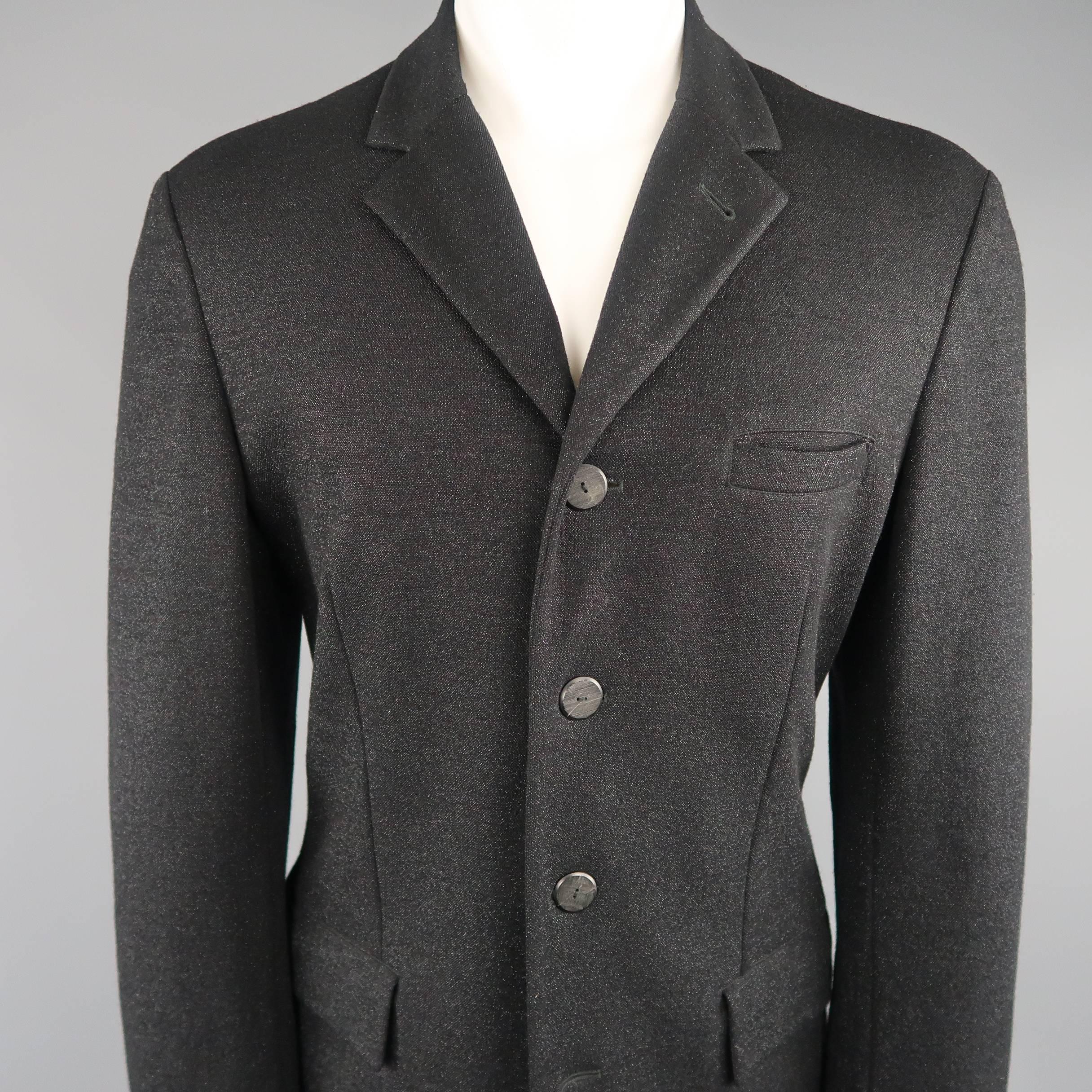 Archive JEAN PAUL GAULTIER HOMME circa 1999 sport coat comes in a black sparkle lurex material with a notch lapel, four wooden button front, and functional button cuffs. Made in Italy.
 
Excellent Pre-Owned Condition.
Marked: 40
 
Measurements:
