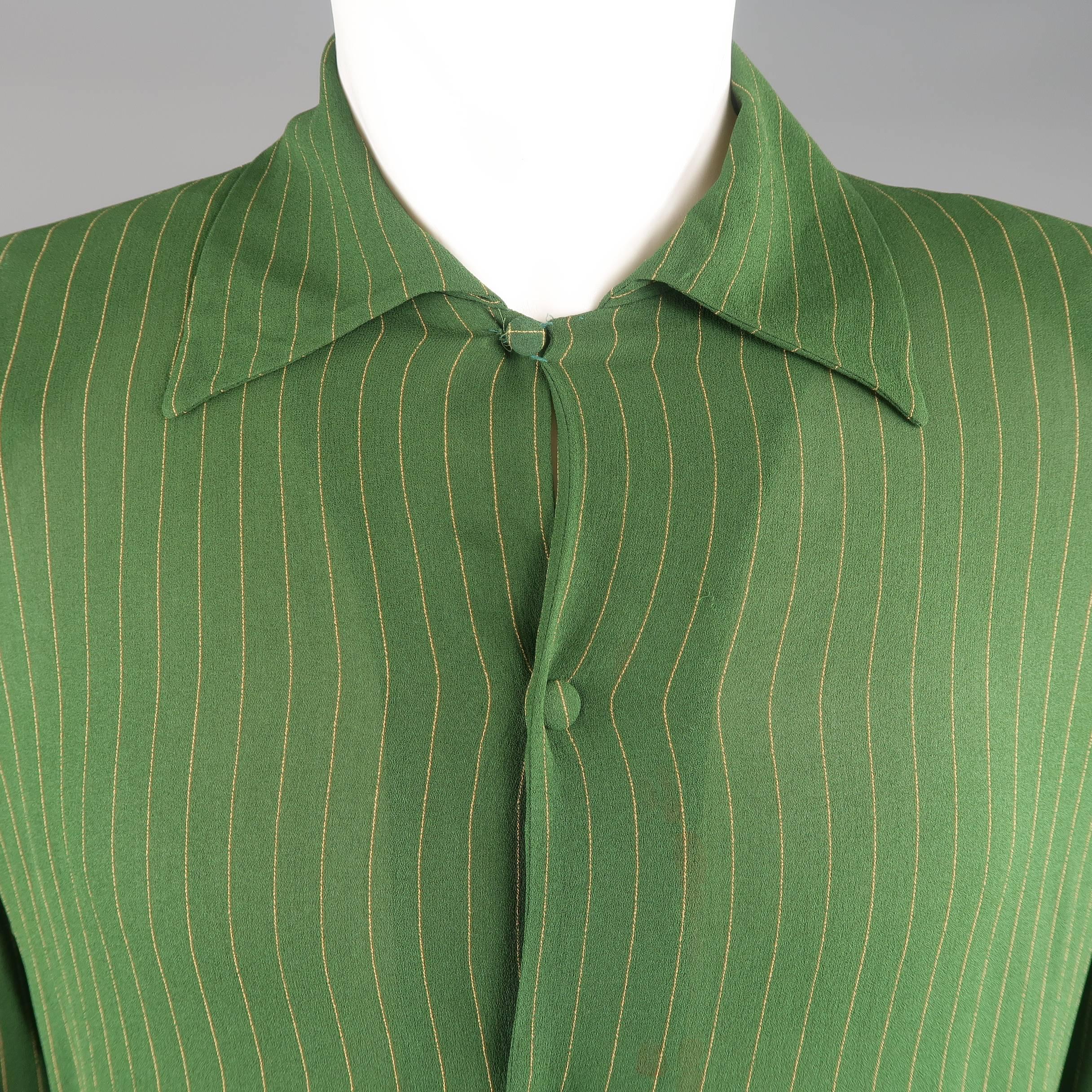 Vintage JEAN PAUL GAULTIER HOMME shirt comes in a green and golden yellow pinstripe crepe and features a pointed collar, covered button snap up front, padded shoulders, French cuffs with button links, and signature back tab detail. Minor wear