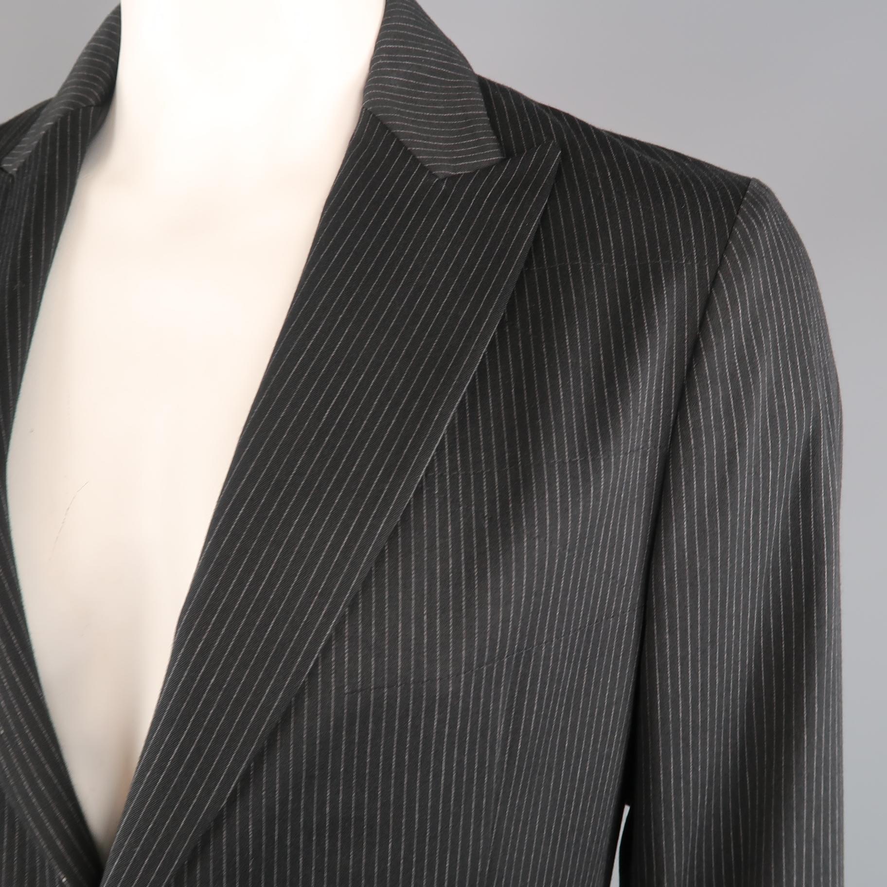 JOHN VARVATOS sport coat comes in black and gray pinstripe fabric with a peak lapel, single breasted, two button front, and leather trim.  Made in Italy.
 
New with Tags.
Marked: IT 52
 
Measurements:
 
Shoulder: 19 in.
Chest: 44 in.
Sleeve: 26