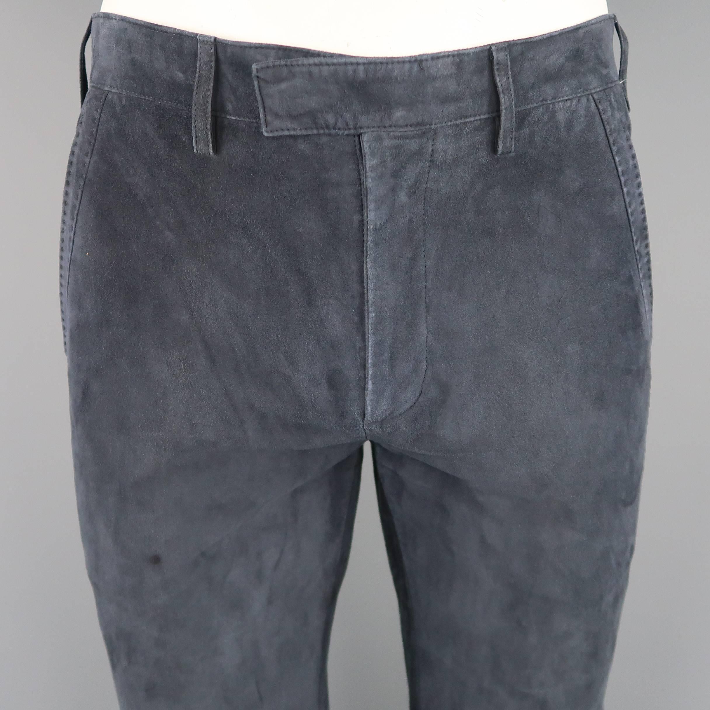 JOHN VARVATOS pants come in muted navy blue suede with a hidden closure tab waistband, zip fly, and top stitch piping throughout. Spot on front and minor wear. Made in Italy.
 
Good Pre-Owned Condition.
Marked: IT 48
 
Measurements:
 
Waist: 32