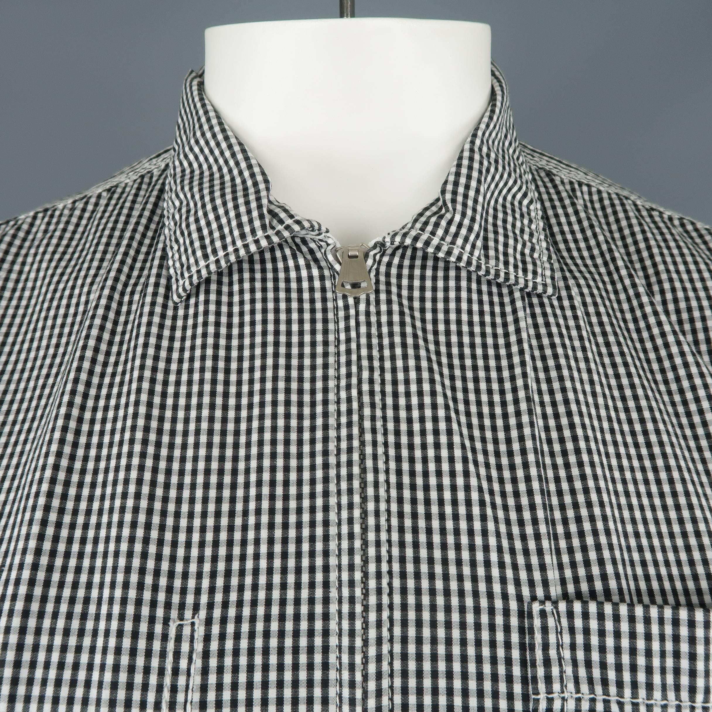 JUNYA WATANABE shirt comes in black and white gingham checkered plaid cotton with a pointed collar, patch pockets, and zip up front. Made in Japan.
 
Excellent Pre-Owned Condition.
Marked: L
 
Measurements:
 
Shoulder: 17 in.
Chest: 42 in.
Sleeve: