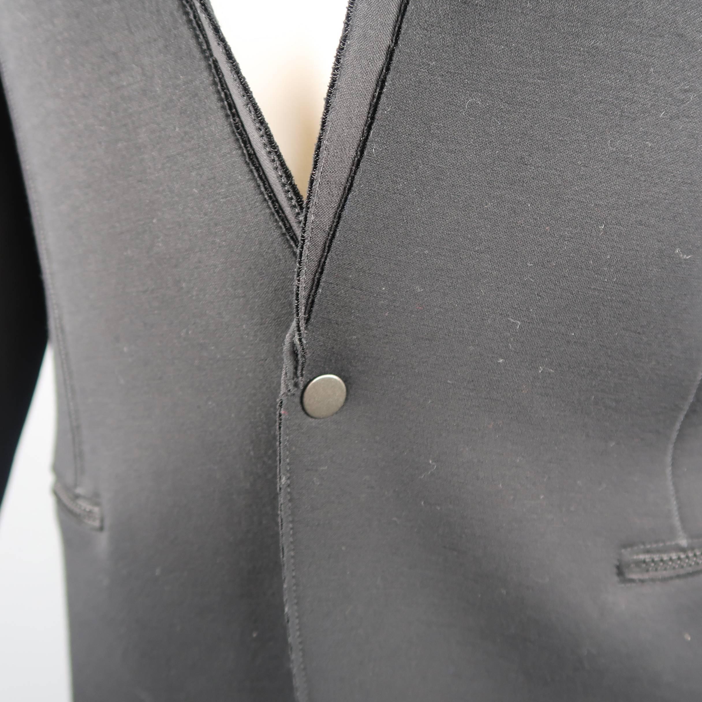 LANVIN sport coat comes in black neoprene material with single snap closure front, zip pockets, reverse seams, and notch lapel. Made in Italy.
 
Excellent Pre-Owned Condition.
Marked: M
 
Measurements:
 
Shoulder: 21 in.
Chest: 42 in.
Sleeve: 23