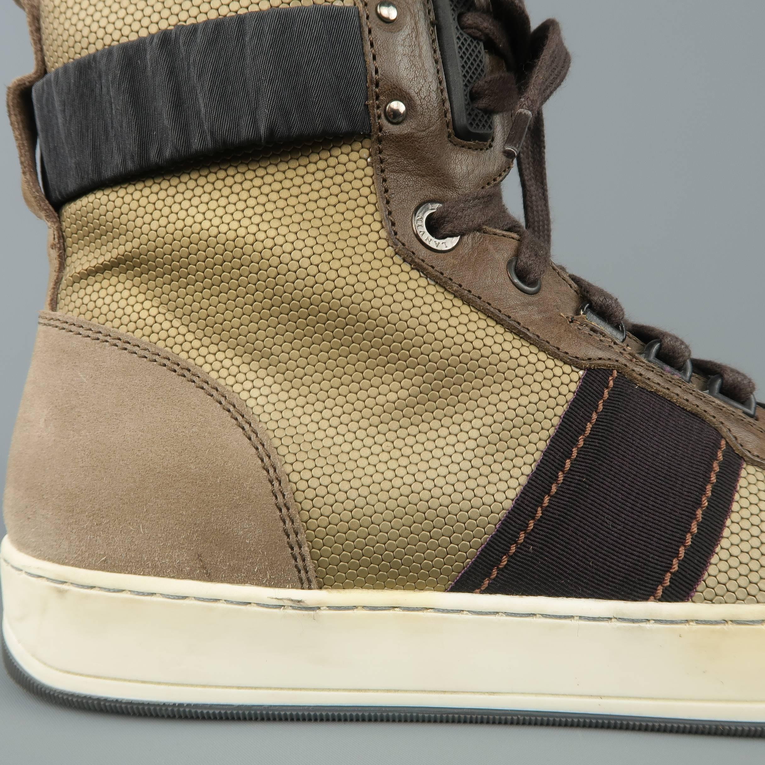 LANVIN high top sneakers come in a metallic dark gold textured fabric with taupe suede and leather details, elastic ankle cuff, and two tone sole. Wear throughout and yellowing of sole. As-is. Made in Italy.
 
Fair Pre-Owned Condition.
Marked: UK 8
