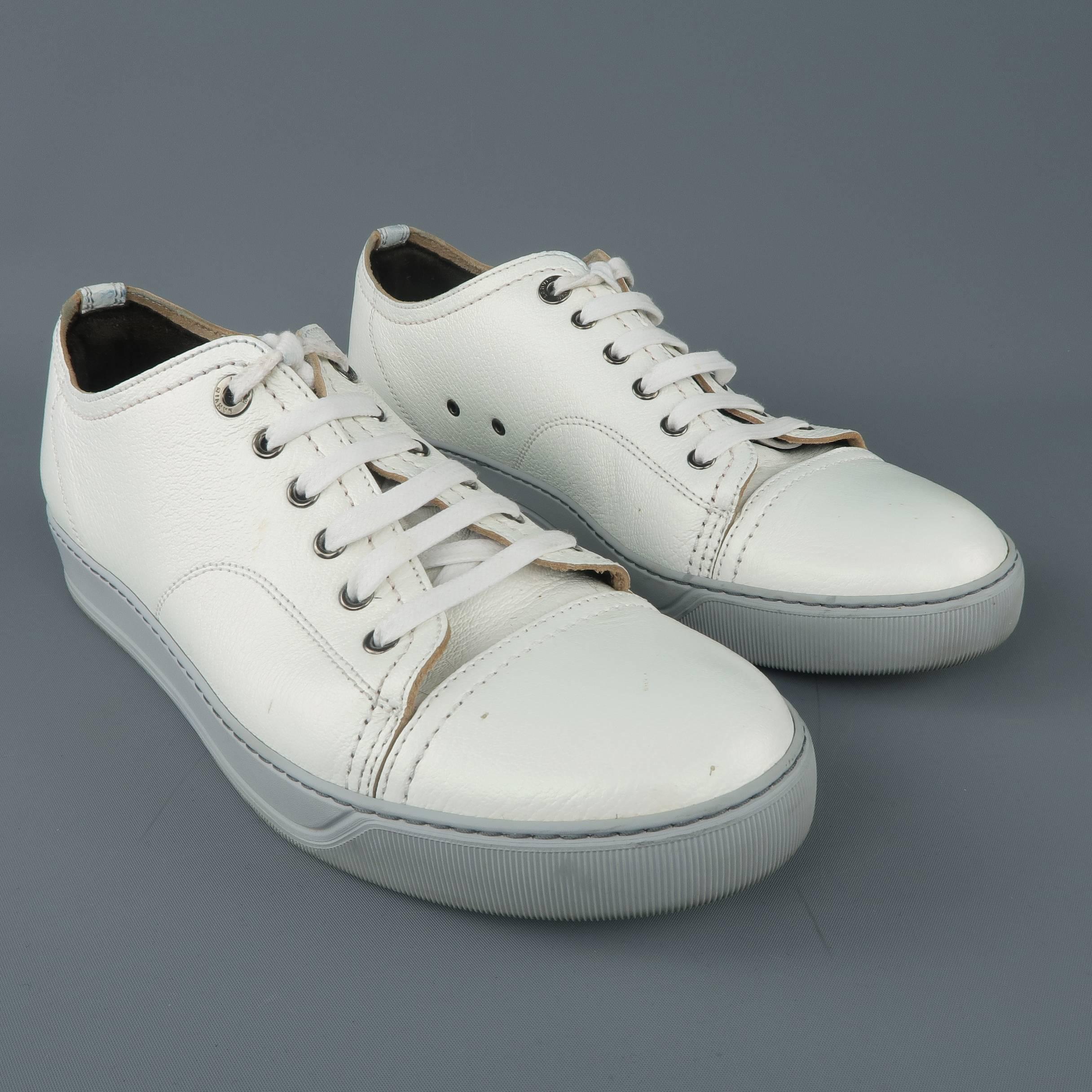 LANVIN low top sneakers come in a unique white textured leather with an iridescent sheen and feature a toe cap, gunmetal grommet lace up front, and silver gray rubber sole. Wear throughout. Made in Portugal.
 
Fair Pre-Owned Condition.
Marked: UK 8
