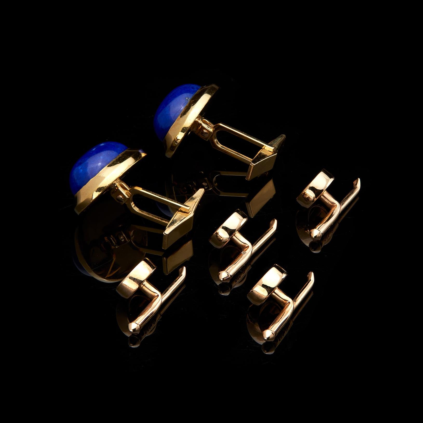 Modern, clean designed gent's dress set. The pair of 18k gold cufflinks are set with oval lapis lazuli cabochons, approximately 17 x 12.8mm, together with four 14k gold shirt studs, each with in-set lapis tablet. Gross weight approximately 27.7