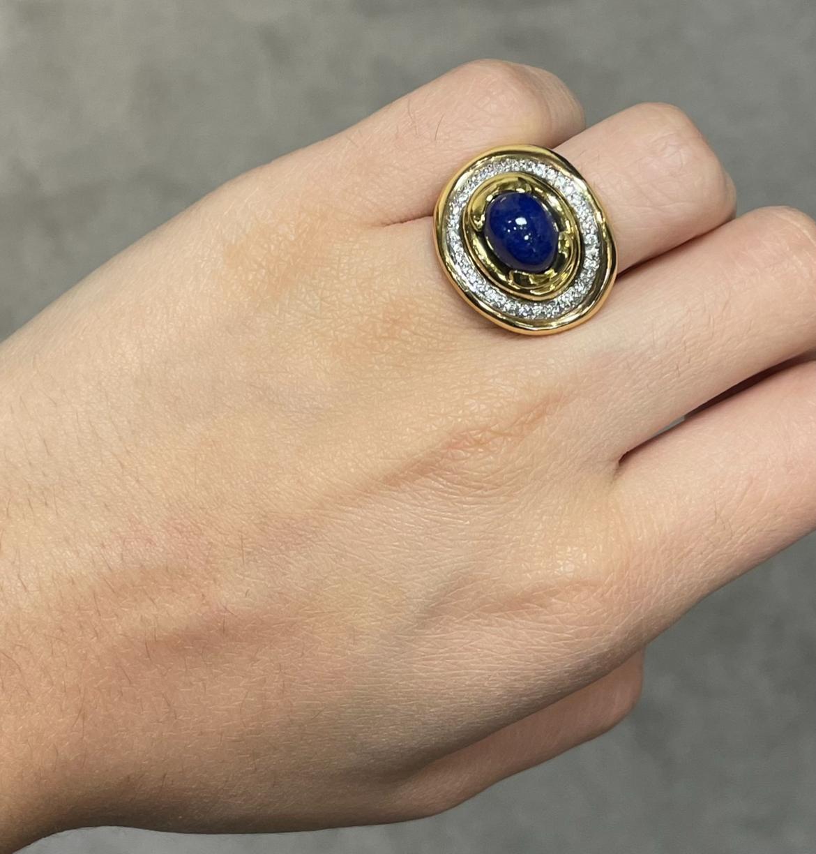 Men's Lapis Lazuli and Diamond Ring 

A yellow gold ring set with lapis lazuli stone accentuated by round-cut diamonds. 

Ring Size: 6.5
Resizable 
Metal Type:  18 karat gold