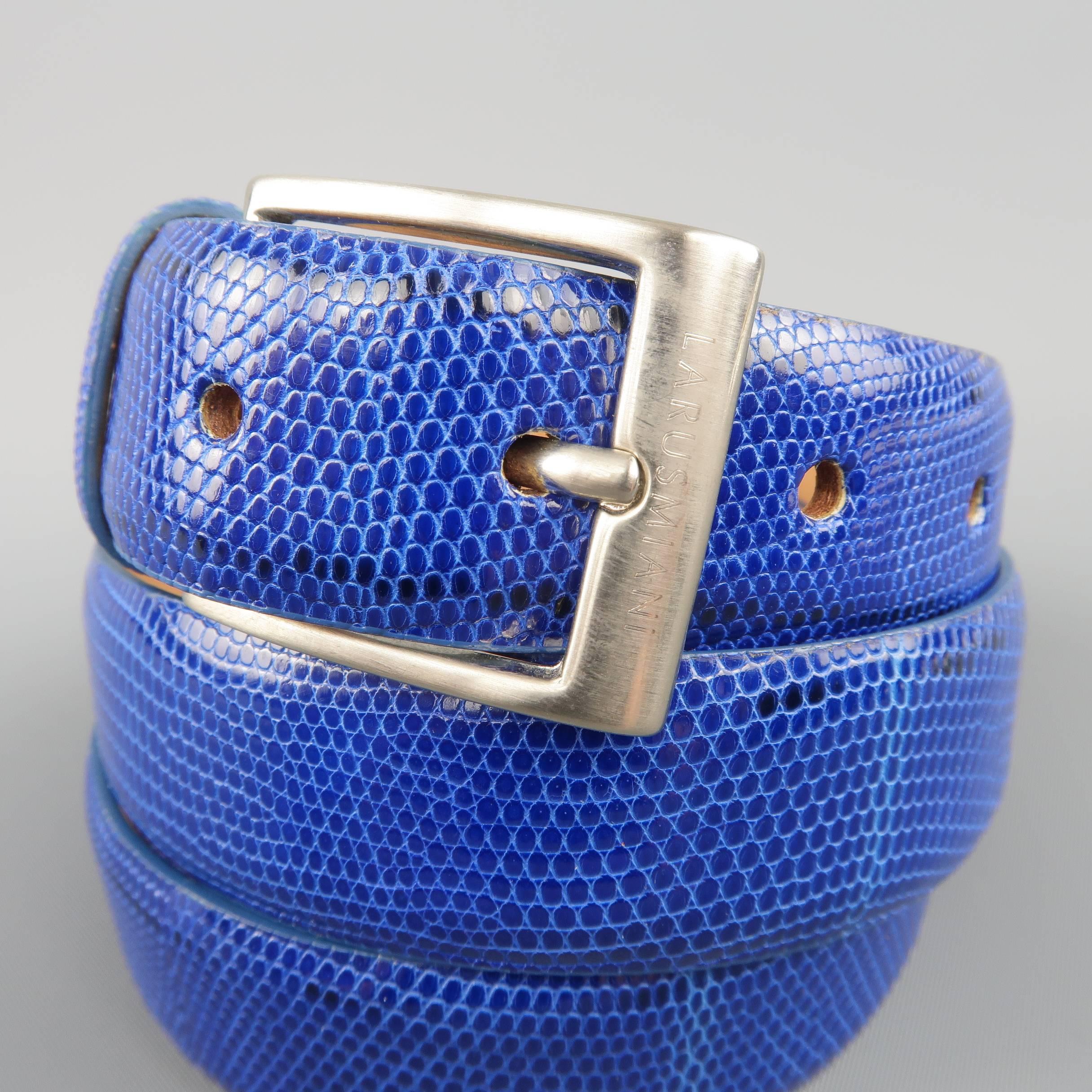 LARUSMIANI dress belt features a royal blue lizard textured leather strap with tan suede liner and matte silver tone brass square buckle. Made in Italy.
 
Good Pre-Owned Condition.
Marked: 95/110
 
Measurements:
 
Length: 43 in.
Width: 1 in.
Fits: