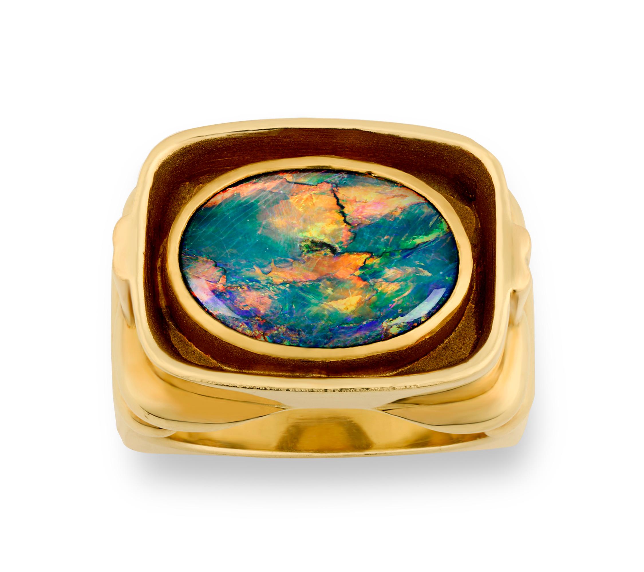 With its vibrant hues of blue, green, orange and yellow, the extraordinary Lightning Ridge opal in this ring weighs approximately 2.50 carats and displays a kaleidoscope of colors. Opals from the Lightning Ridge mines in Australia are known for