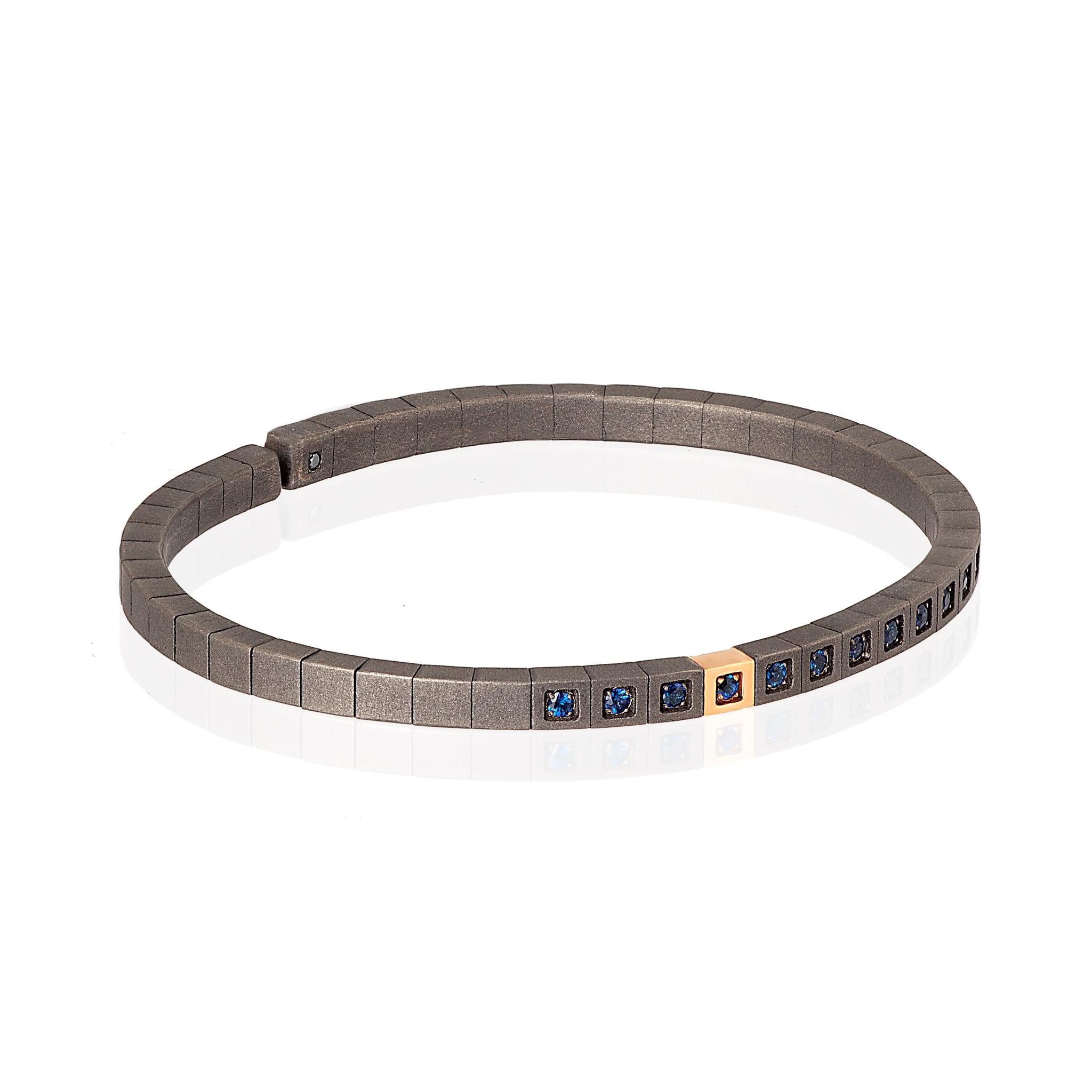 Men's Loop line bracelet in titanium, 9 kt red gold and blue sapphires. A precious bracelet with an innovative design in which a long series of titanium cubes are joined together by an internal spring, which gives flexibility to the entire