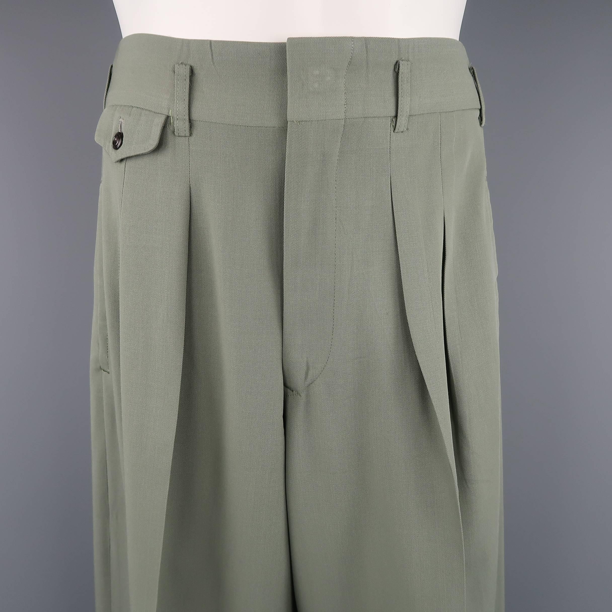 Vintage MATSUDA dress pants come in sage green wool twill with a high ride, box pleated front, wide tapered leg, cuffed hem. Made in Japan.
 
Good Pre-Owned Condition.
Marked: (No size)
 
Measurements:
 
Waist: 33 in.
Rise: 12.5 in.
Inseam: 31 in.

