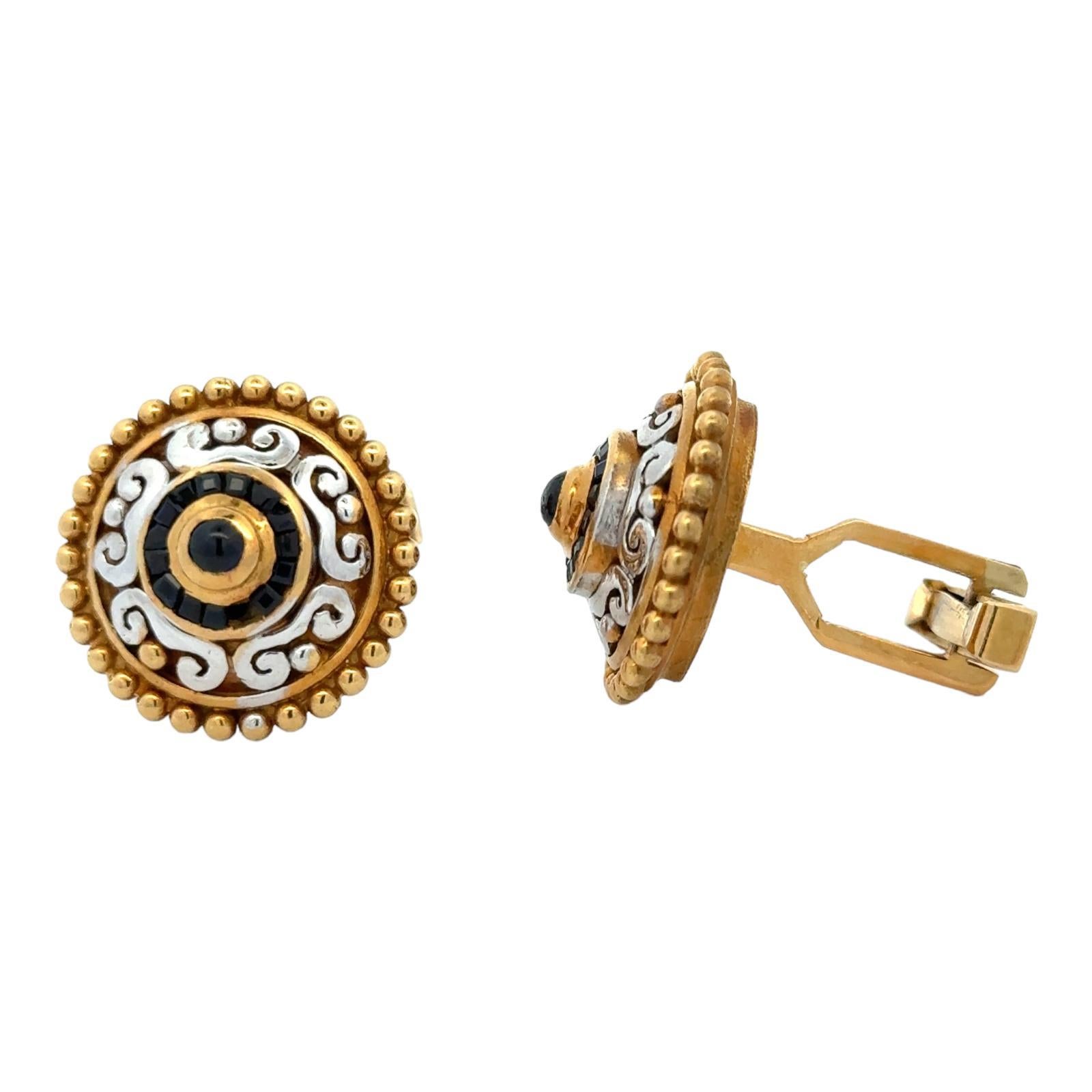 Contemporary men's cufflinks crafted in 18 karat white & yellow gold. The cufflink finding is 14 karat yellow gold. They feature blue sapphire gemstones and measure 20mm in diameter. Weight: 22.3 grams.