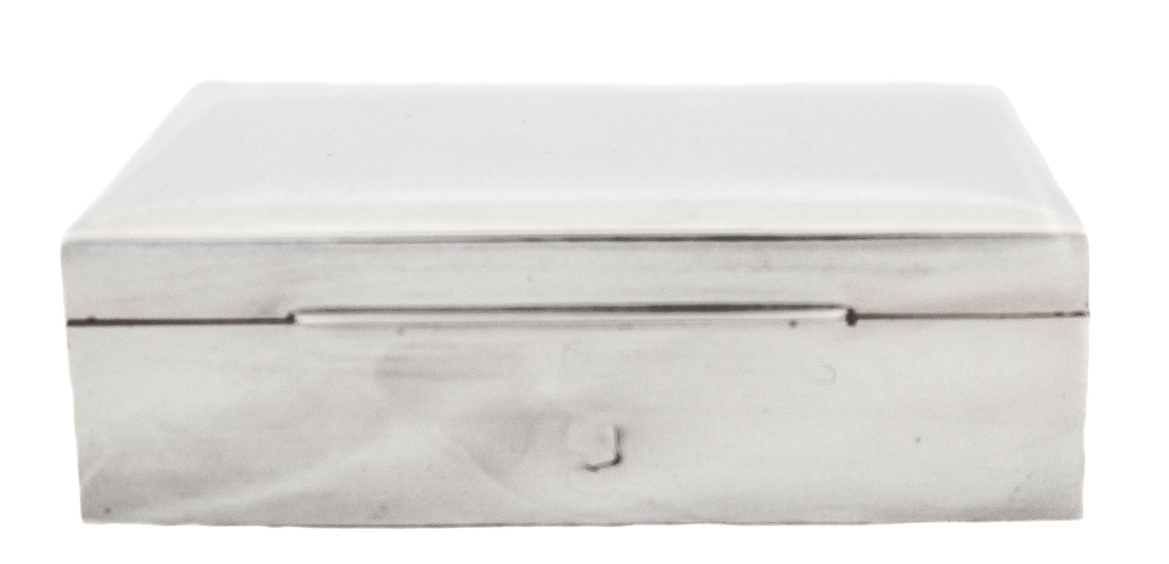 Being offered is a men's sterling silver jewelry box. It is from the 1950s and has that Classic Midcentury look; sleek and Minimalist. The inside is wood that we have had restrained so it’s pristine. The outside shows some sign of age, which is