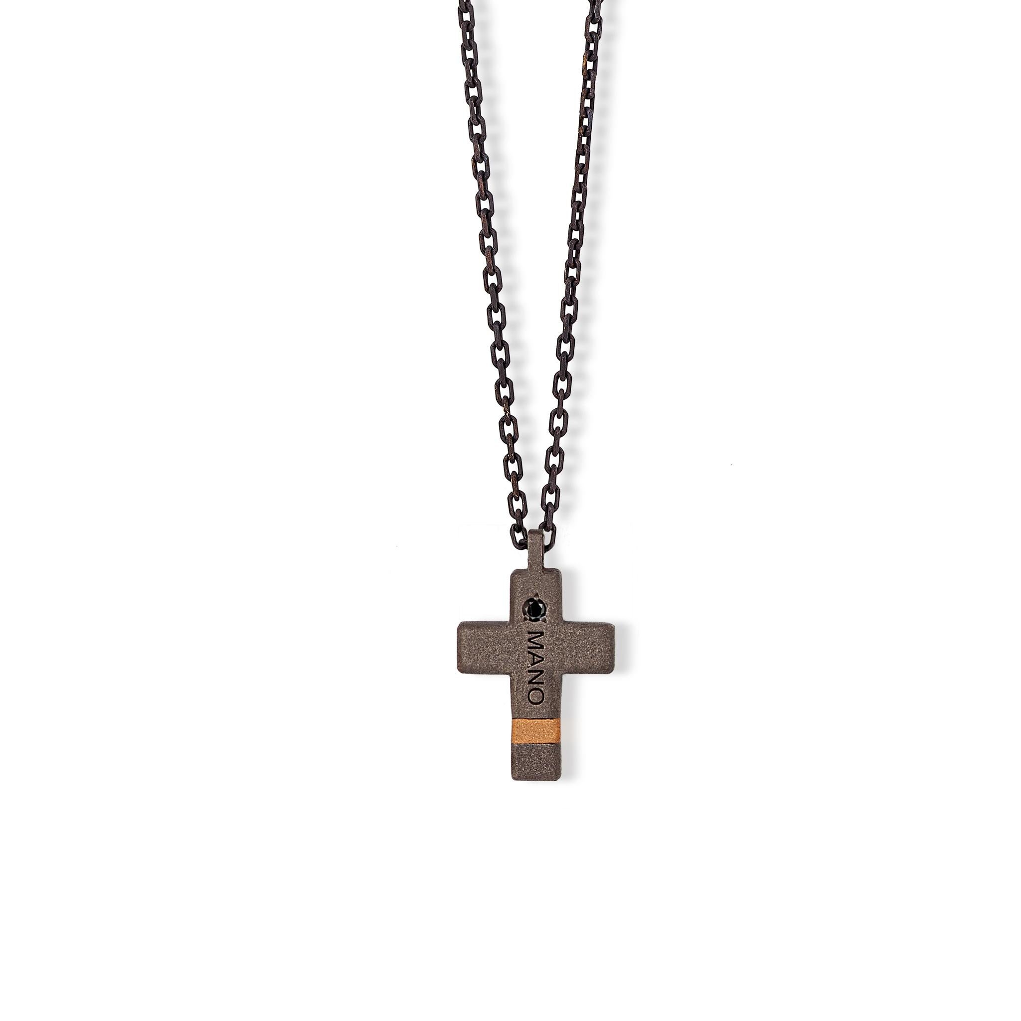 Men's necklace made of titanium, black diamonds and 18 kt red gold, 9 kt red gold and chain. Alongside the titanium, this cross features an 18 kt red gold insert as an element of preciousness. 10 black diamonds, equal to a carat of 10 points, cover