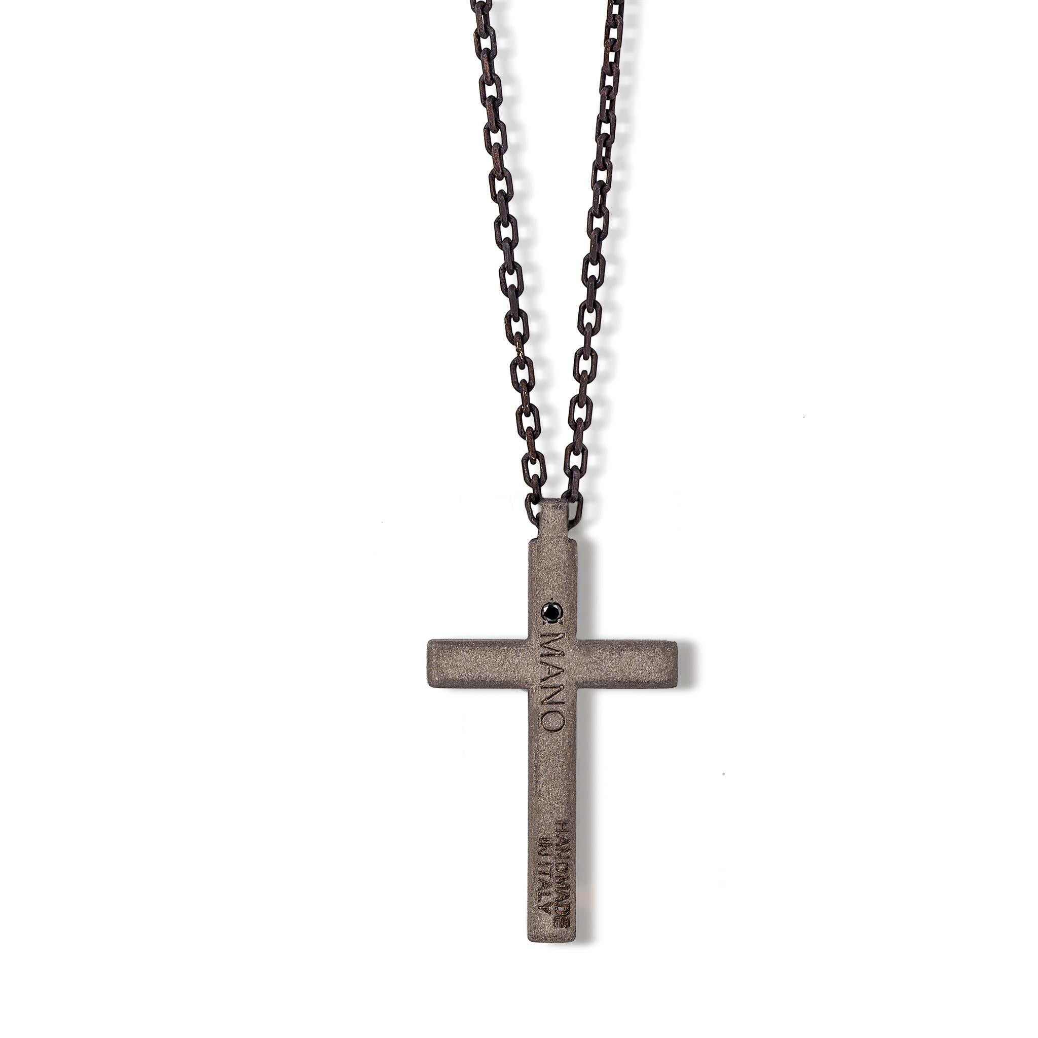 Men's necklace in titanium,white diamonds,9 kt red gold and chain. The titanium cross is set with 4 white diamonds for a total carat of 4 points. Through a loop above the cross passes a silver chain on the end of which are two 9 kt red gold links
