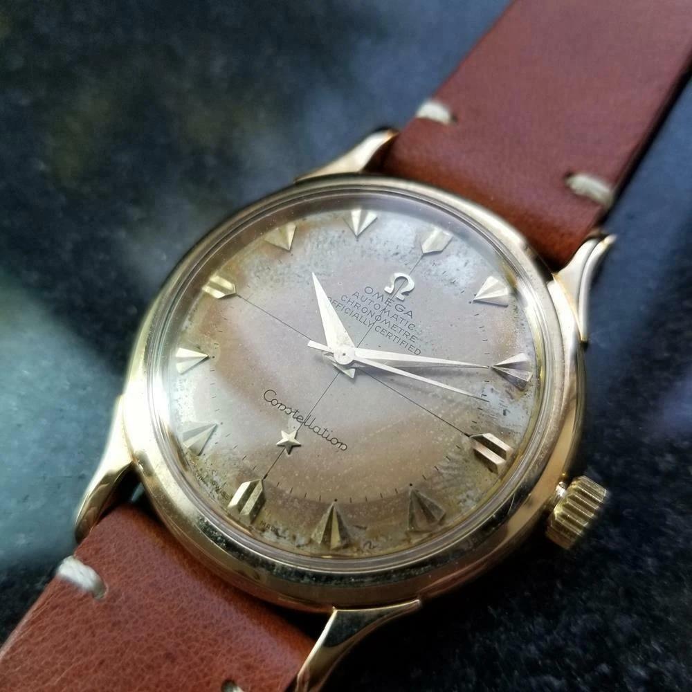 Timeless classic, men's 14k gold Omega Constellation De Luxe automatic, c.1954. Verified authentic by a master watchmaker. Original, unrestored Omega dial, tanned with age, applied gold faceted triangle hour markers, gold minute and hour hands,