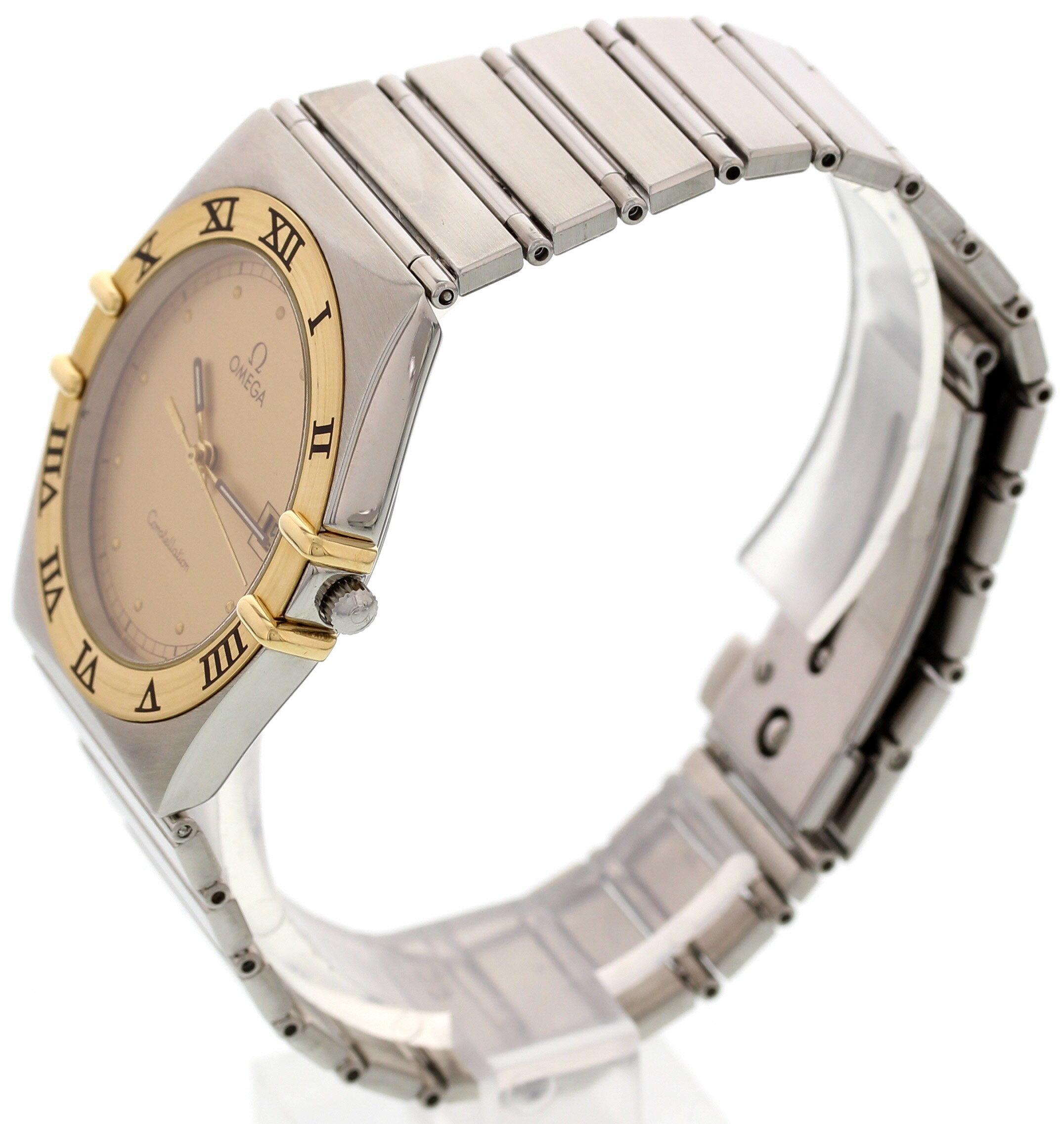 Men's Omega Constellation watch. Stainless steel 32 mm case. 18k yellow gold fixed bezel with black Roman numerals.  Gold dial with luminous hands and gold markers. Date display. Stainless steel bracelet with push button sliding clasp. Quartz