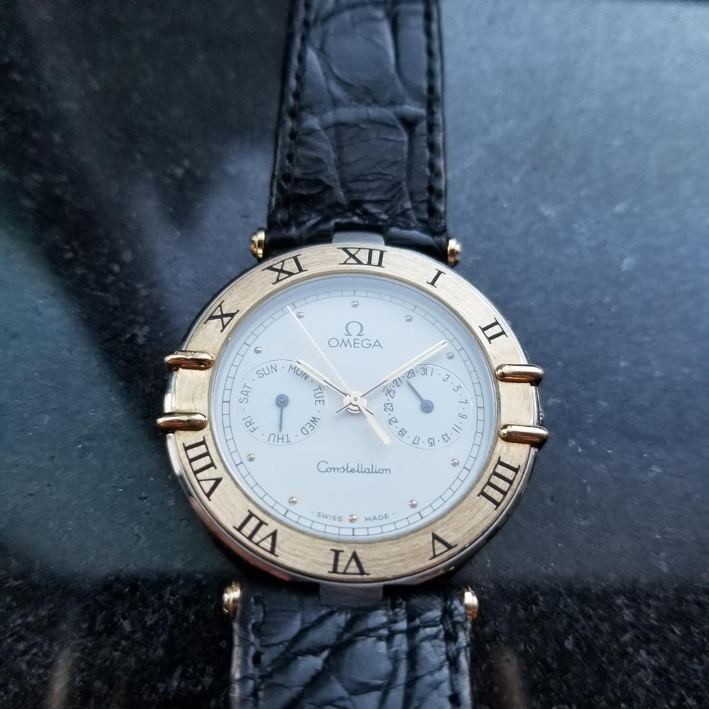 Iconic classic, Men's Omega Constealltion day date quartz, c.1995, all original. Verified authentic by a master watchmaker. Gorgeous Omega signed white dial, applied gold droplet hour markers, day and date subdial at the 9 and 3 position, lumed gilt