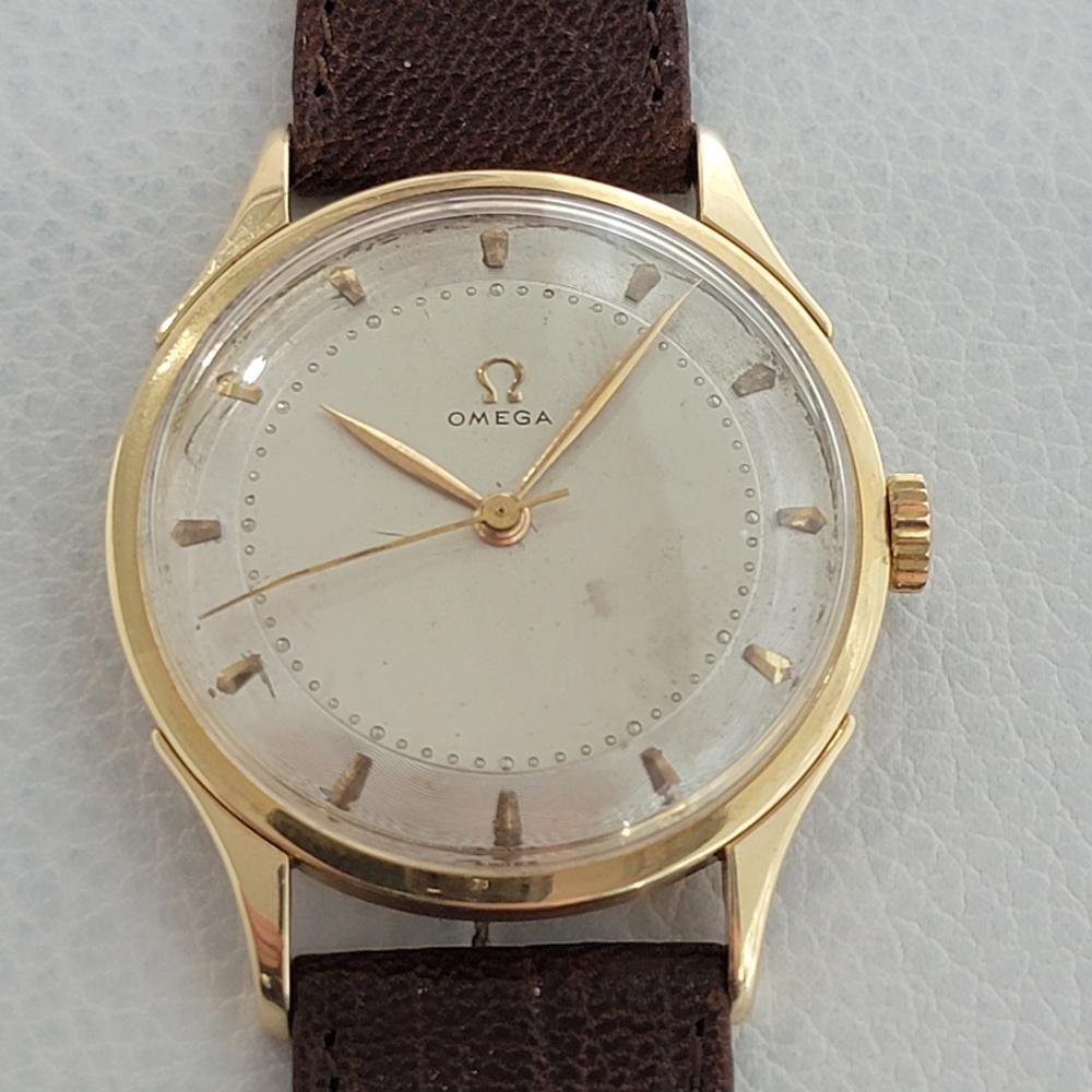 Timeless classic, Men's Omega solid 14k gold manual hand-wind dress watch, c.1947. Verified authentic by a master watchmaker. Gorgeous Omega signed piepan dial, applied indice hour markers, droplet minute markers, gold minute and hour hands,