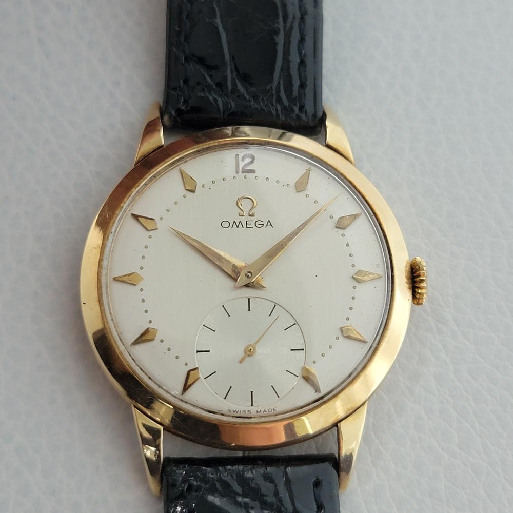 Luxurious classic, Men's Omega solid 14k gold Tresor manual hand-wind dress watch, c.1954. Verified authentic by a master watchmaker. Gorgeous Omega signed two tone dial, applied dagger indice hour markers, Arabic numeral 12, droplet minute markers,