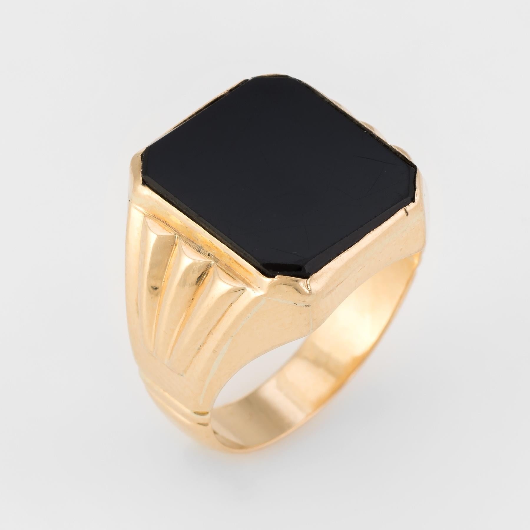Finely detailed men's cocktail ring (circa 1960s to 1970s), crafted in 18 karat yellow gold. 

Onyx is inlaid flush into the mount and measures 15mm x 13mm. The onyx is in excellent condition and free of cracks or chips. Few light surface abrasions