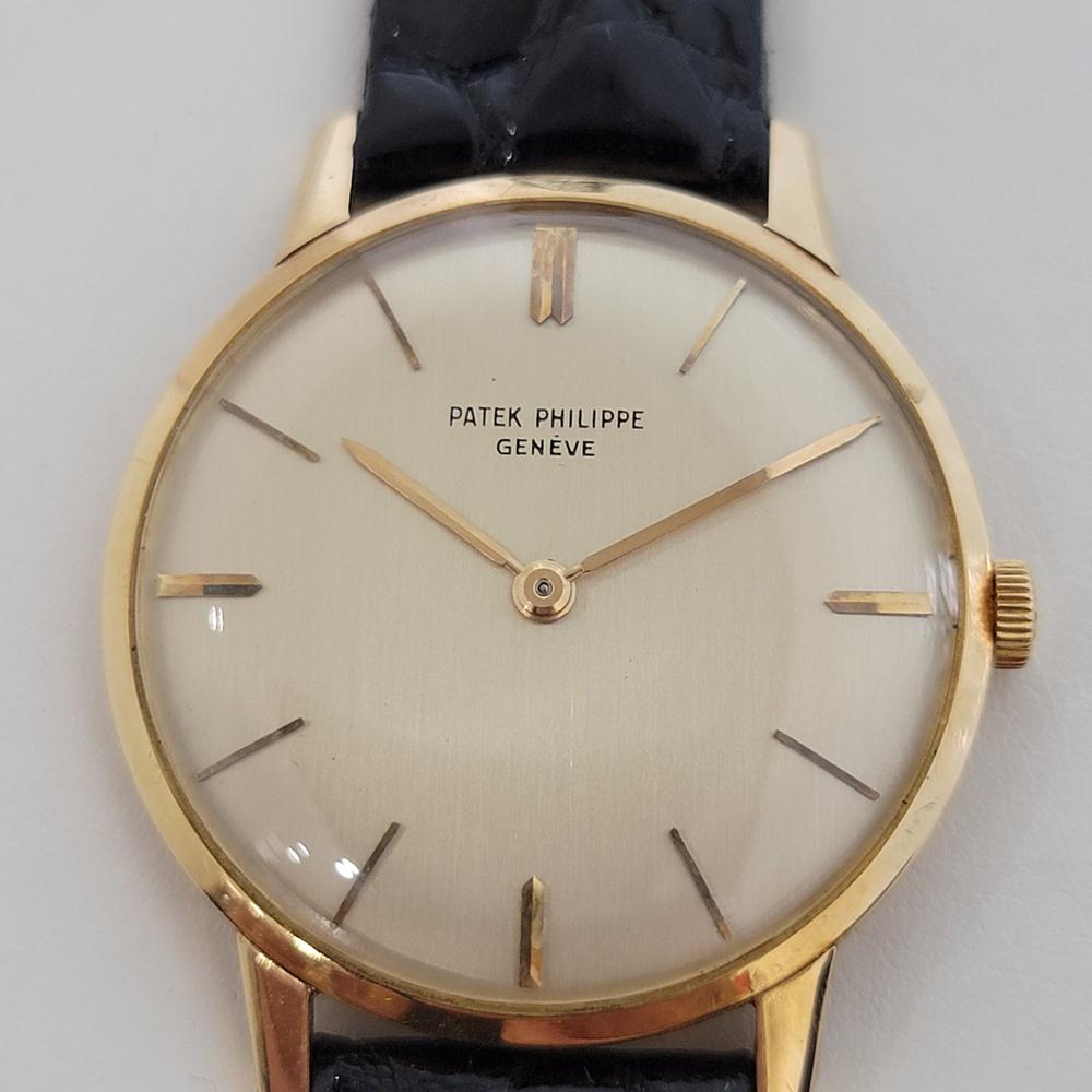 Timeless luxury, Men's 18k solid gold Patek Philippe Calatrava Ref 2599 manual wind dress watch, c.1960s. Verified authentic by a master watchmaker. Gorgeous Patek Philippe signed champagne dial, Geneve hallmarked, applied indice hour markers, gilt