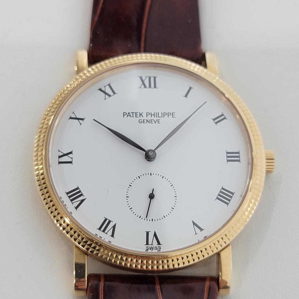 Timeless luxury, Men's 18k solid gold Patek Philippe Calatrava Ref 3919 manual wind dress watch, c.1980s. Verified authentic by a master watchmaker. Gorgeous Patek Philippe signed white dial, Geneve hallmarked, Roman numeral hour markers, leaf